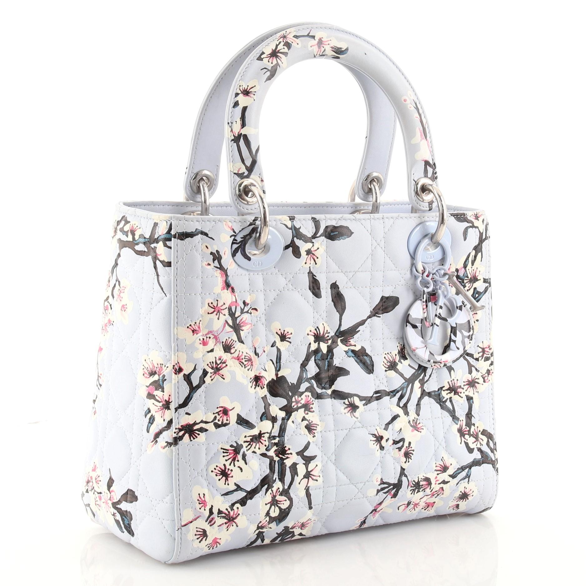 Condition: Good. Darkening, wear, scuffs and marks on exterior, handles and strap, moderate wear on opening trim. Scuffs, indentations and marks in interior, scratches and tarnish on hardware.
Accessories: Charms, Detachable Strap
Measurements: