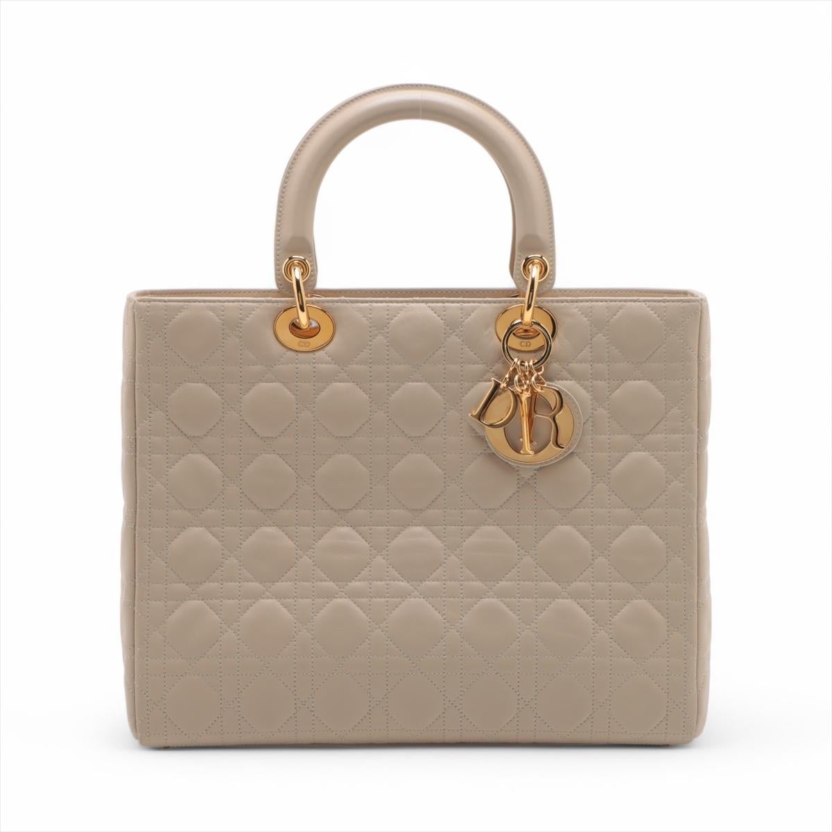 *will ship about 4/1

The Christian Dior Lady Dior Cannage Large Leather Handbag in Beige is an iconic symbol of elegance and sophistication. Crafted from luxurious lambskin leather, it features the signature Cannage quilting, showcasing Dior’s