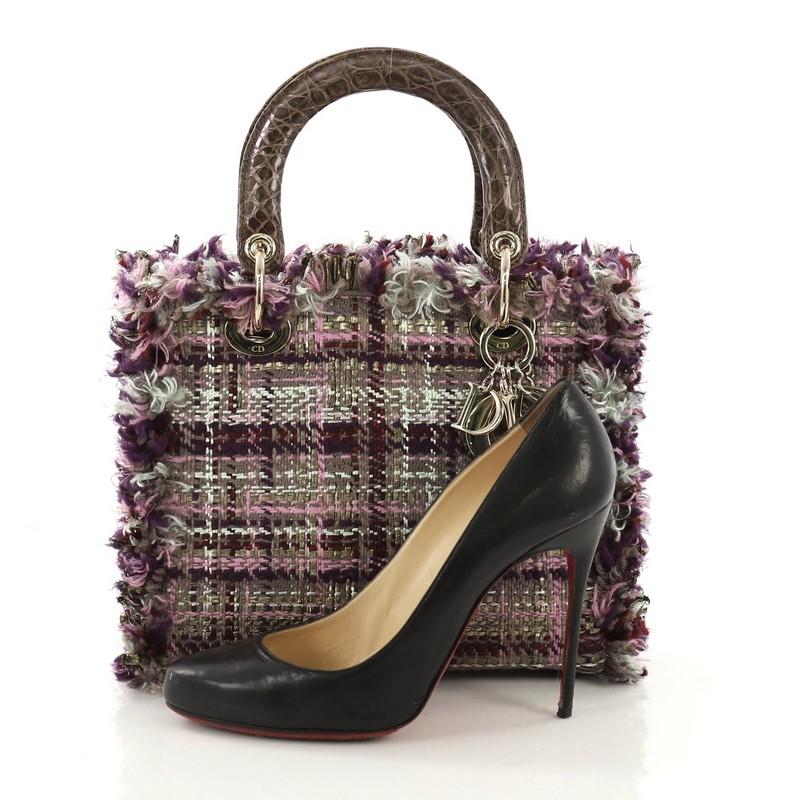 This Christian Dior Lady Dior Handbag Tweed with Crocodile Medium, crafted from purple tweed with genuine crocodile, features dual rolled handles, sleek Dior charms, and gold-tone hardware. Its zip closure opens to a pink leather interior with side