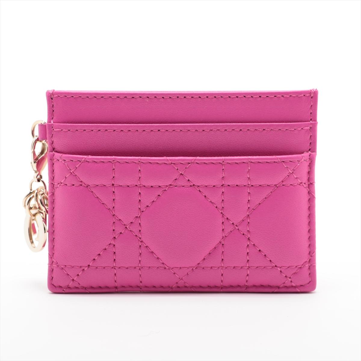 The Christian Dior Lady Dior Lambskin Cannage Card Case in Fuchsia Pink epitomizes luxury and sophistication. Crafted from sumptuous lambskin leather, the card case showcases Dior's iconic Cannage quilting, exuding timeless elegance. Its compact