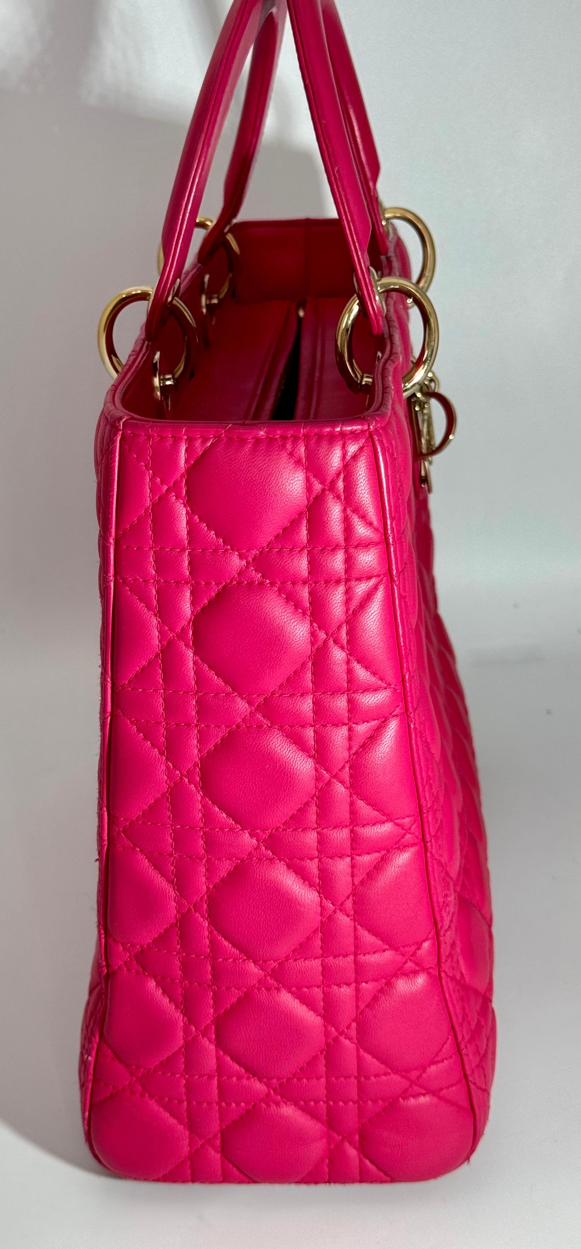 Pre-owned. The Lady Dior handbag epitomizes the House's vision of elegance and beauty. Sleek and refined, the timeless yet relevant style is crafted in cherry red lambskin with Cannage stitching, creating the instantly recognizable quilted texture.