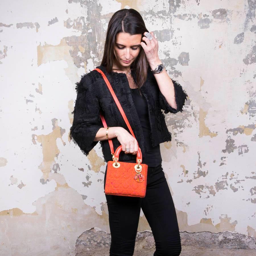 Christian Dior 'Lady Dior' mini bag in coral tweed and Coral smooth lamb leather finishes. Matte gilded metal hardware. Block multicolored charms 'D.I.O.R'. 

Worn by hand or on shoulder. Removable shoulder strap. Interior: lining in brown monogram