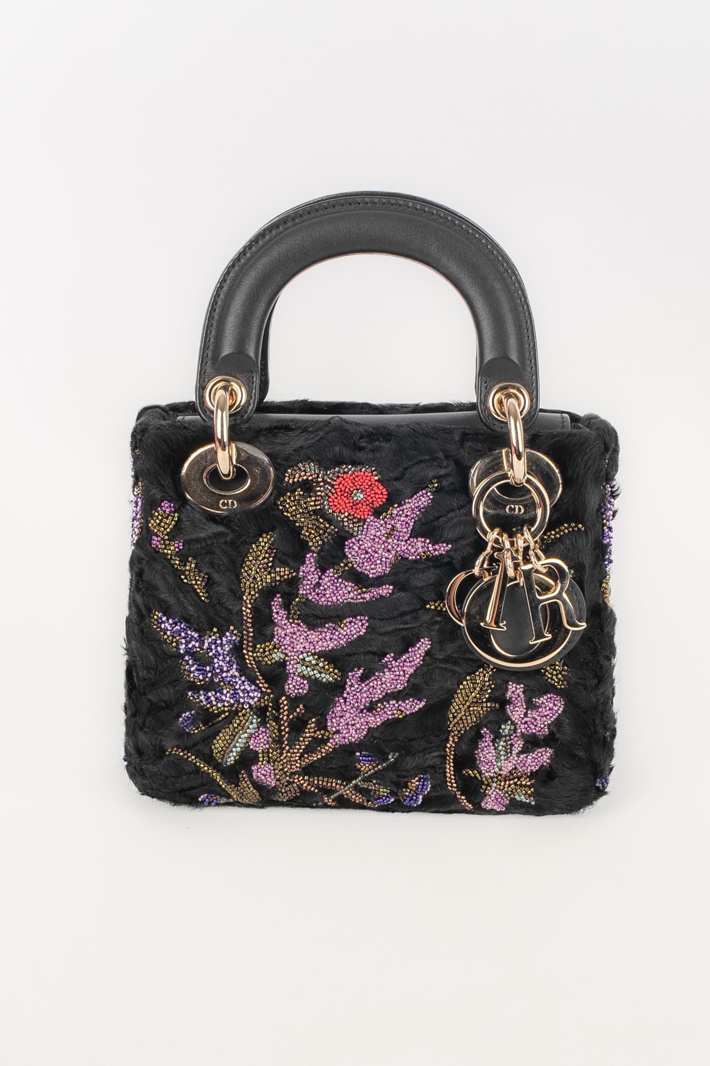 DIOR - (Made in Italy) Black Astrakhan Lady Dior mini bag embroidered with multicolored pearl flowers, and with a removable golden chain and black leather strap. Piece with an authenticity card. A 2019 Limited Edition Collection.

Condition:
Very