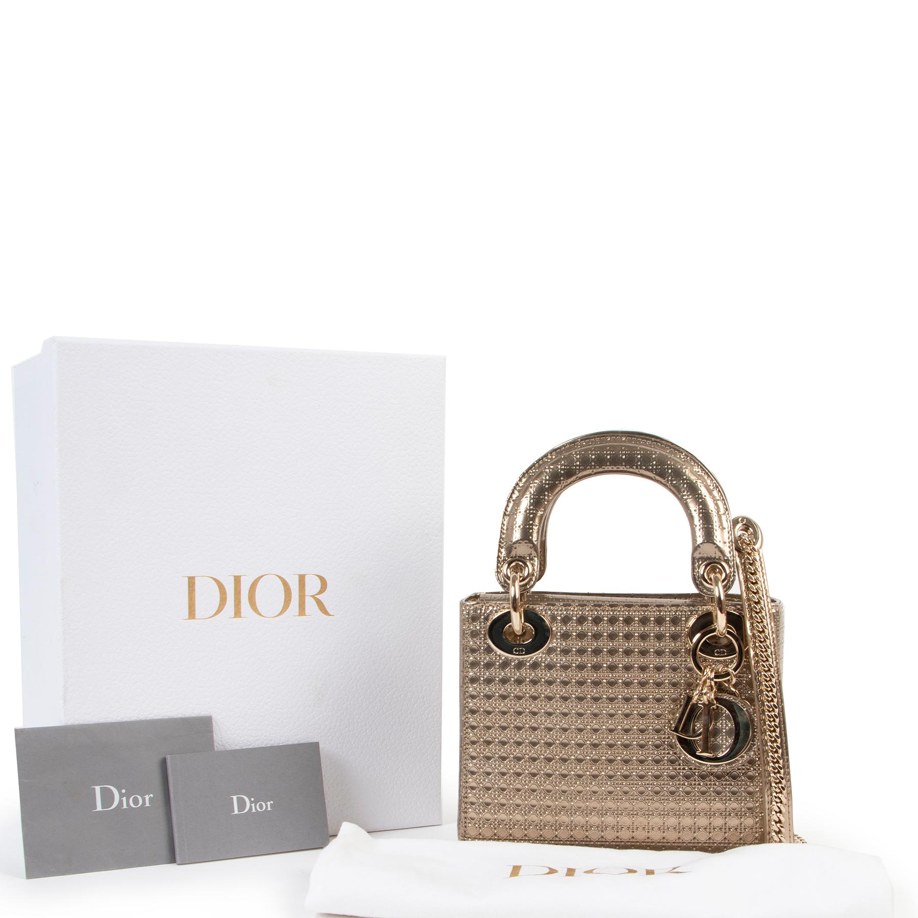 Christian Dior Lady Dior Mini Gold Micro Cannage Bag

The Lady Dior handbag embodies Maison Dior's elegance. This sleek and refined style is crafted in gold metallic leather and embossed with Micro Cannage pattern for evening allure. The gold-finish