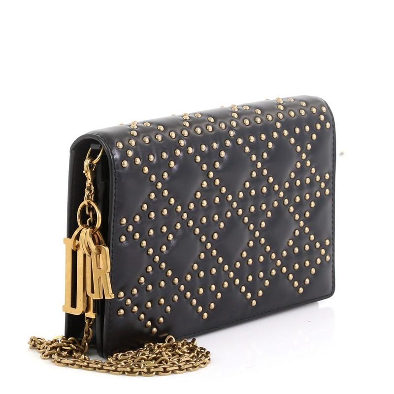 
This Christian Dior Lady Dior Wallet on Chain Cannage Studded Leather, crafted from black cannage studded leather, features chain link shoulder strap and aged gold-tone hardware. Its snap closure opens to a black leather interior with zip and slip
