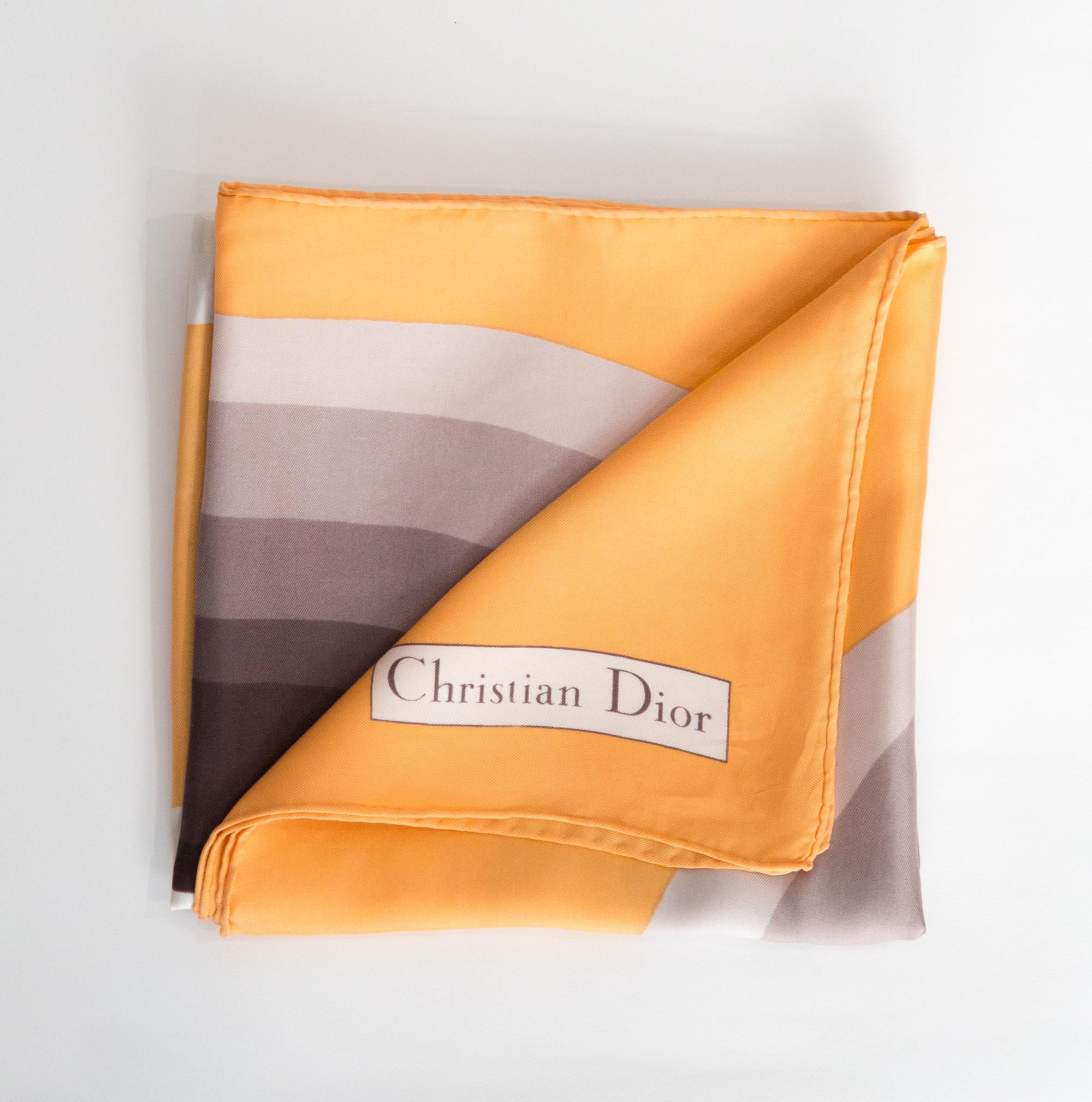 Christian Dior Silk Scarf featuring a light orange ground, a large 