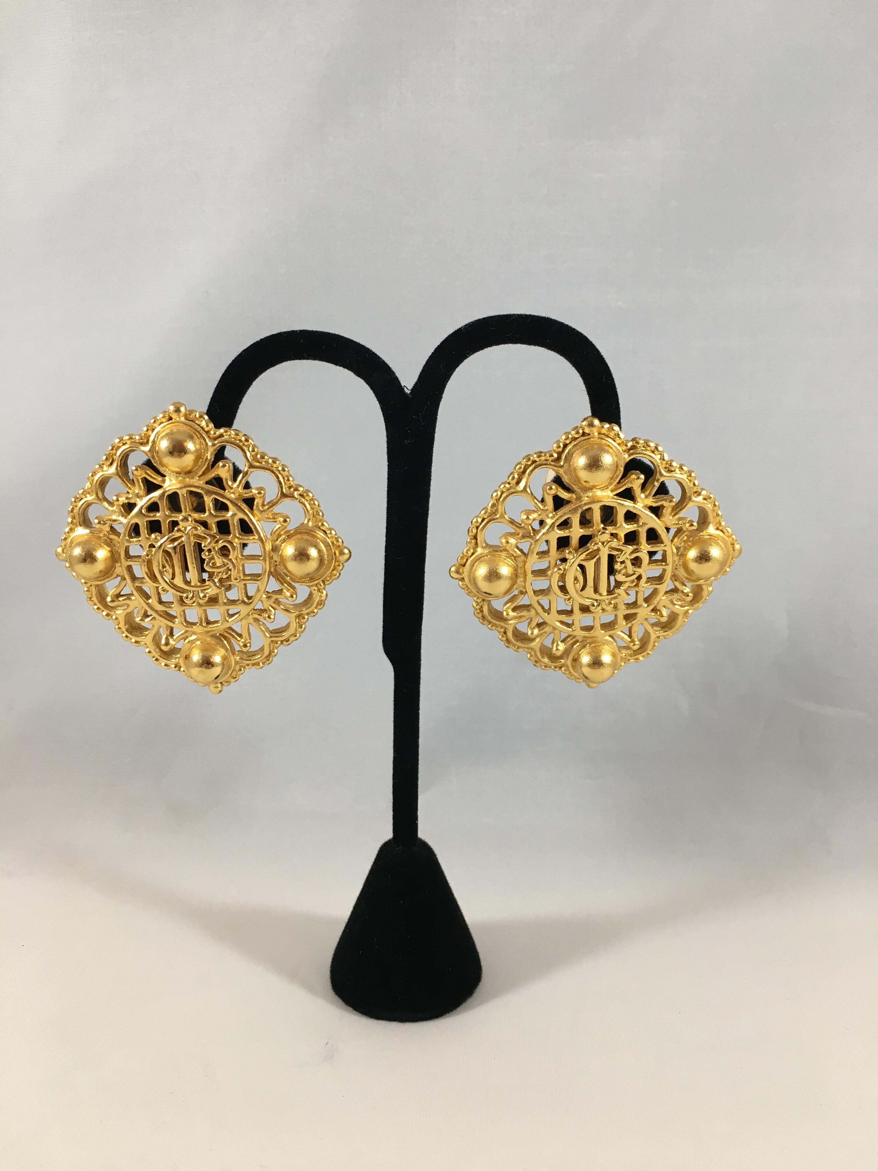 Spectacular Christian Dior gold-tone logo clip-on earrings. These earrings are fabulous and ready to made a statement. They feature an interlocking Christian Dior monogram used by Dior since the 1950s. The earrings are beautifully crafted and are