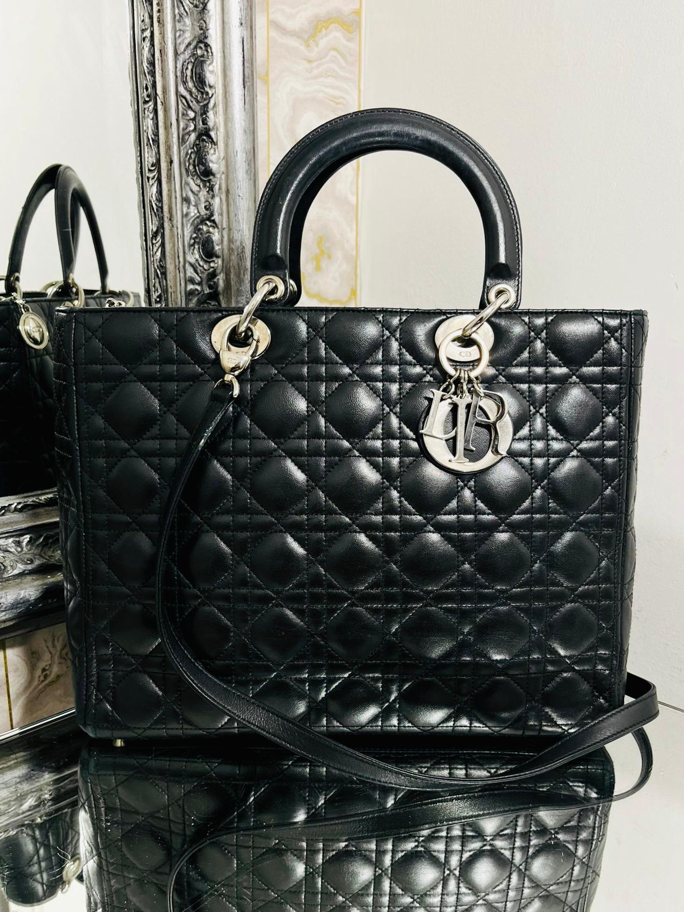 Christian Dior Large Model Lady Dior Bag

Black Lambskin leather in the iconic cannage stich pattern. Top carry

handle and removable shoulder strap. Silver hardware to include 'DIOR' logo charm.

Rrp £5,600.

Size - Large Model - Height 25cm, Width