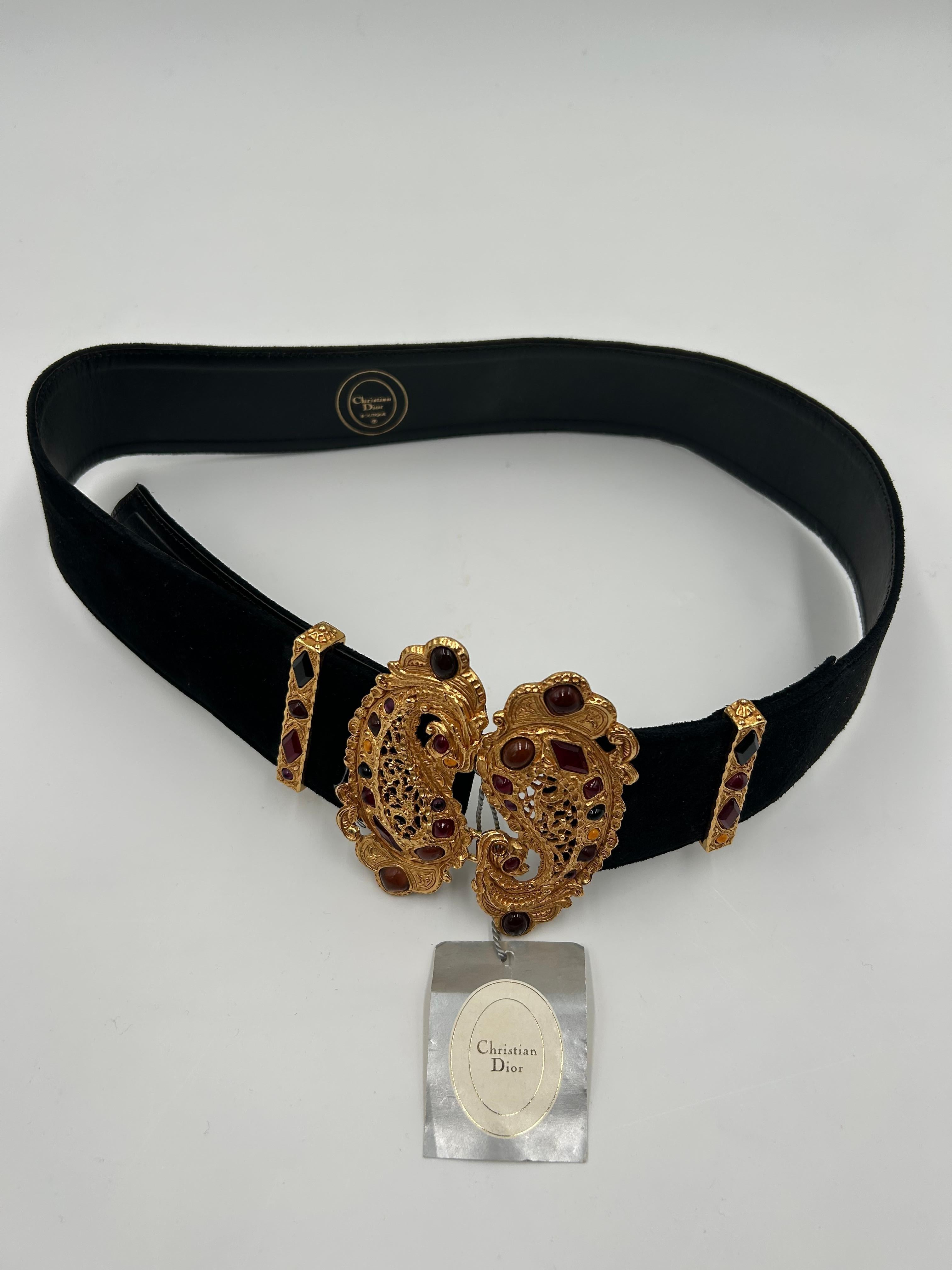 Christian Dior leather and Gripoix belt is a luxurious and statement-making accessory that fuses classic craftsmanship with ornate detailing. The belt is crafted from high-quality leather and features a bold, structured silhouette that cinches the
