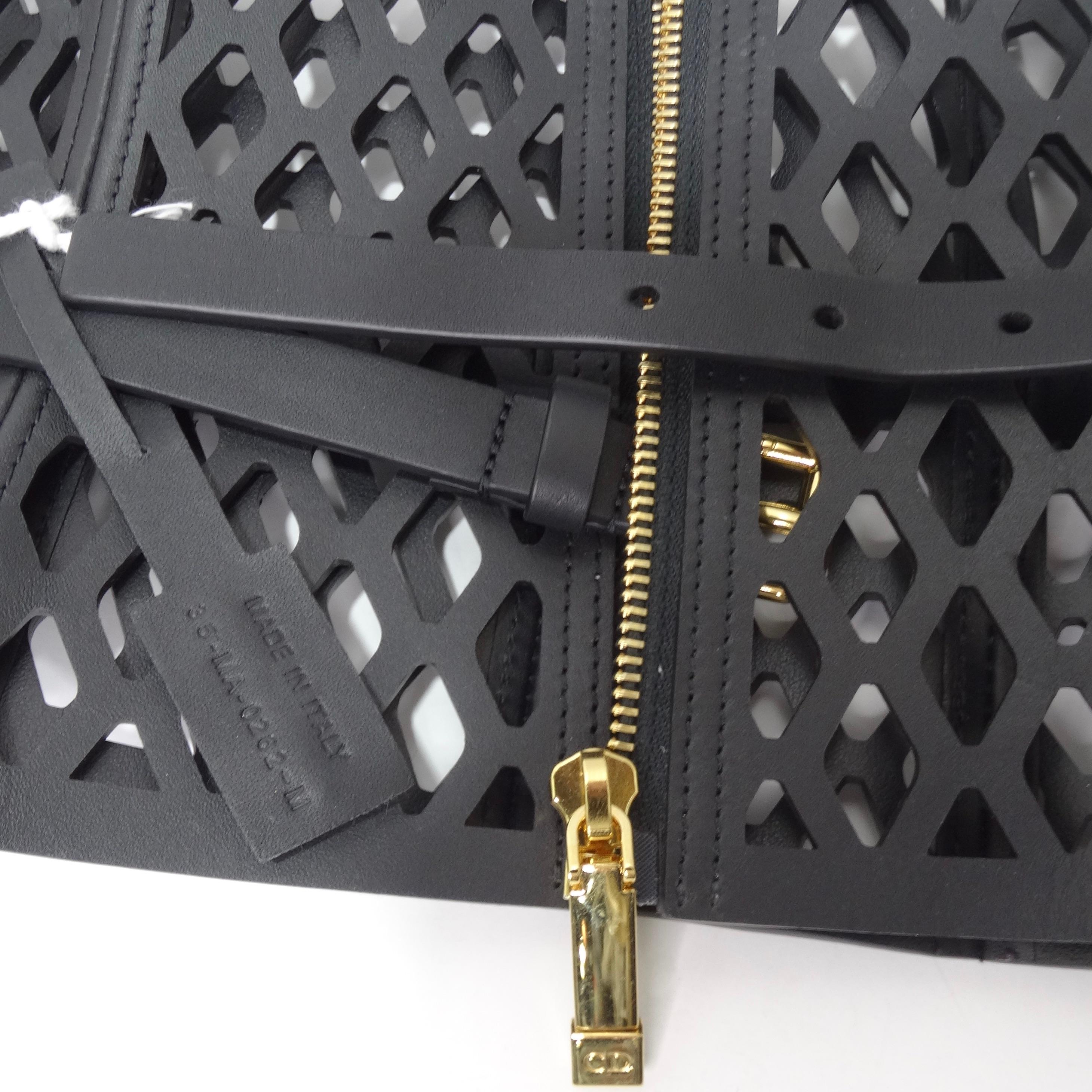 This super unique Dior belt is begging to be added to your wardrobe! With its structured leather cut-out motifs this statement belt is sure to spice up any outfit. Featuring a zipper and gold belt buckle hardware that is adjustable. Pair this over