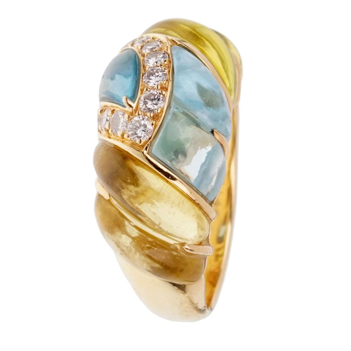 A fabulous vintage Dior ring with alternating lemon quartz and blue topaz set in 18k yellow gold. The ring is adorned with round brilliant cut diamonds.

Size 7 (Resizeable)