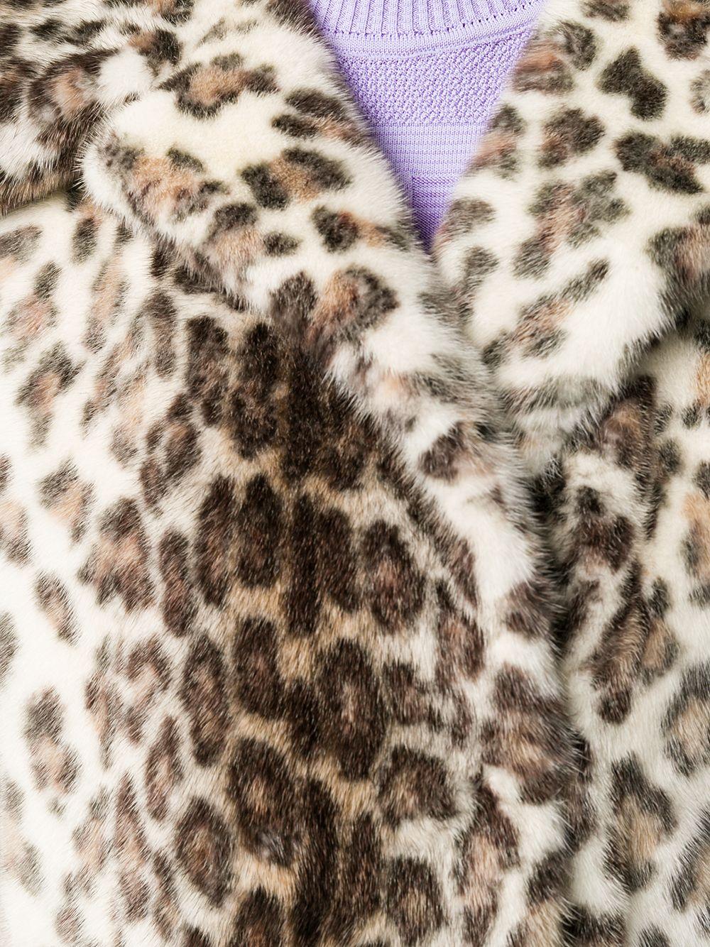 Crafted in France from pure mink, this pre-owned, 1920's inspired, fur coat by Christian Dior features a shift silhouette, a distinctive leopard print exterior, three-quarter length sleeves and a concealed front hook fastening. Falling just below
