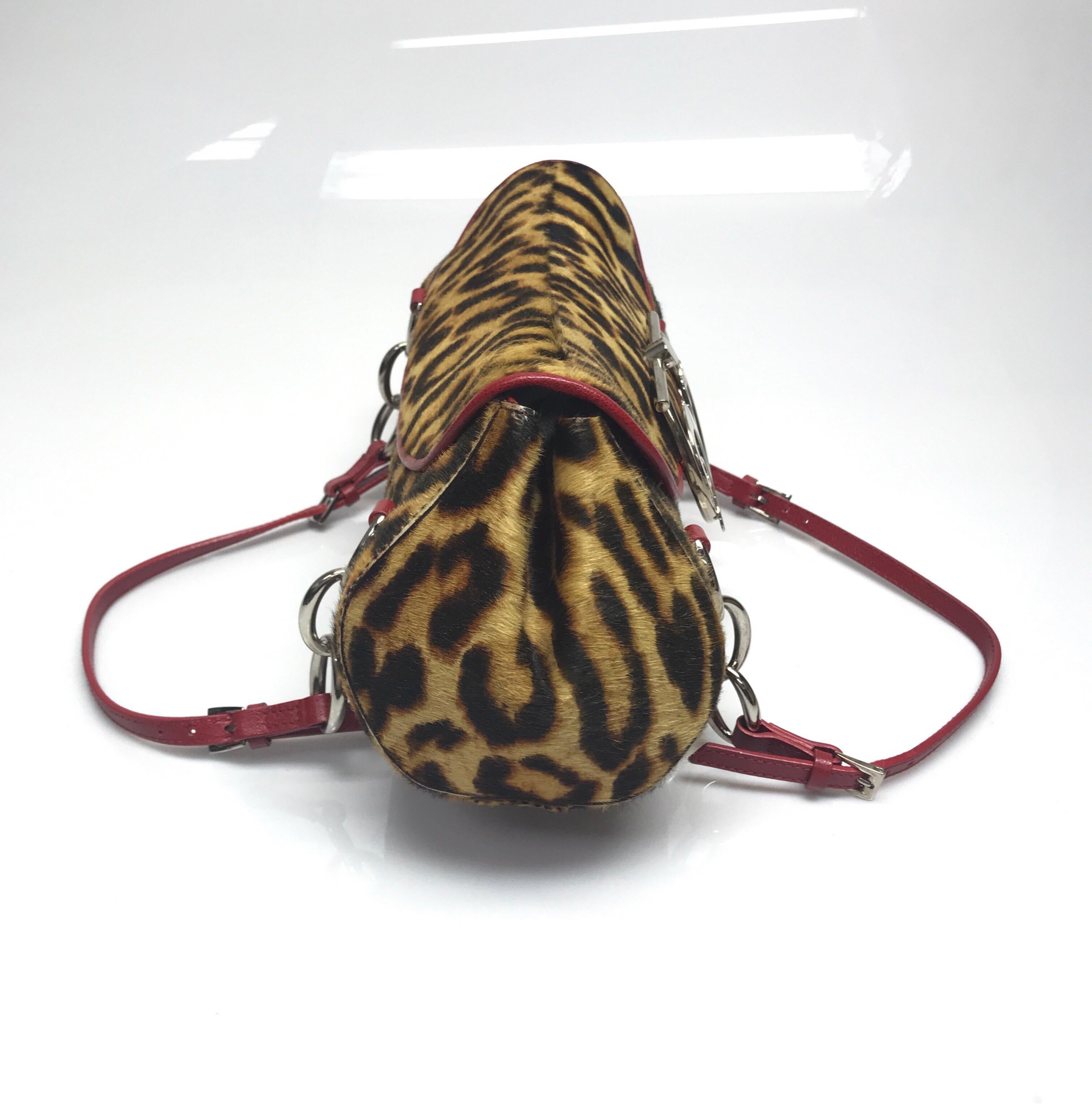 Christian Dior Leopard Print Pony Hair Handbag. This amazing Christian Dior handbag is in excellent condition, there is no sign of use. This handbag is medium sized and made of pony hair with a leopard pattern. There is red leather trim around the