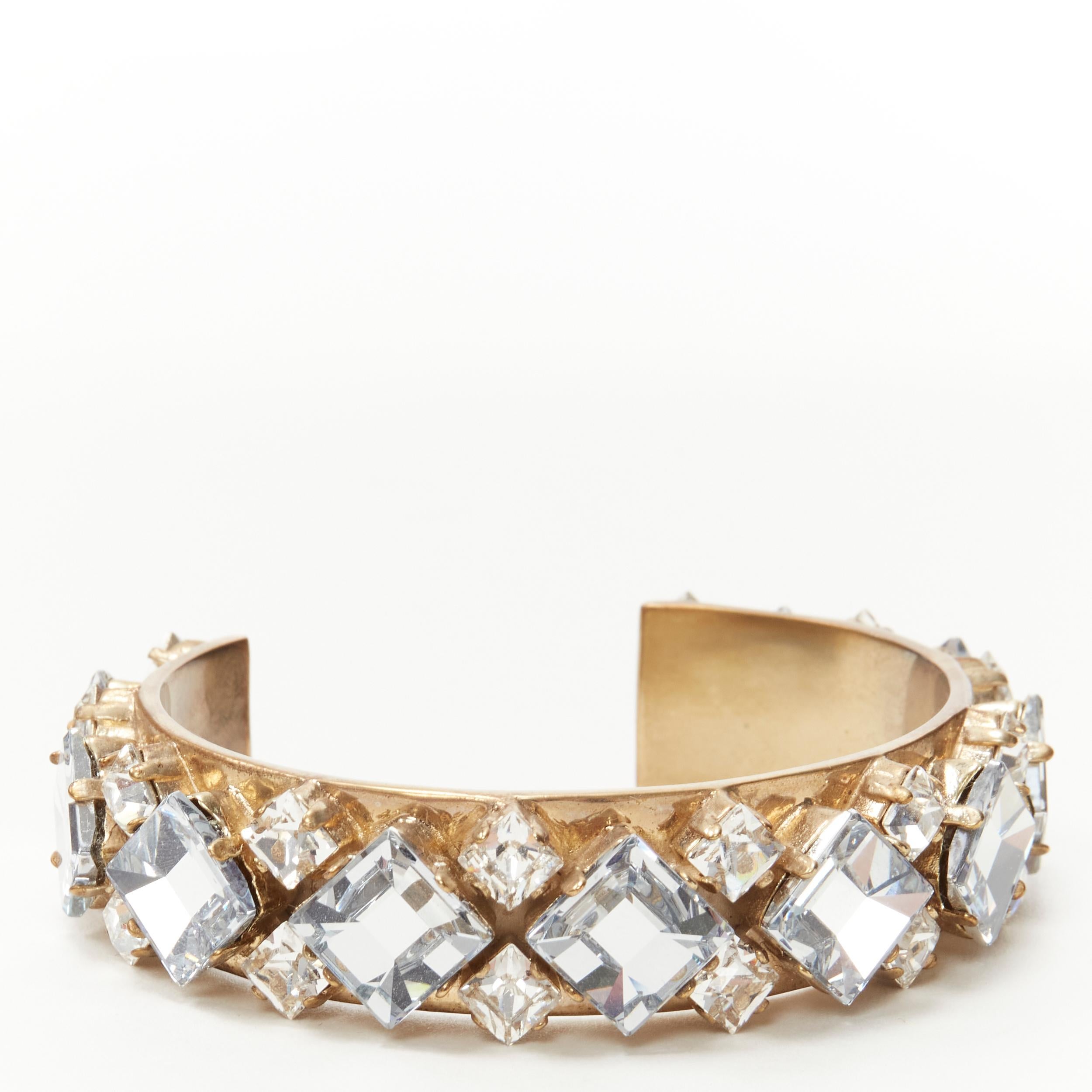 CHRISTIAN DIOR light blue clear square crystal jewel gold-tone cuff bangle M 
Reference: KEDG/A00009 
Brand: Christian Dior 
Material: Metal 
Color: Gold 
Extra Detail: Metal was designed to be pre-oxidized for an antique brushed finishing. Blue and