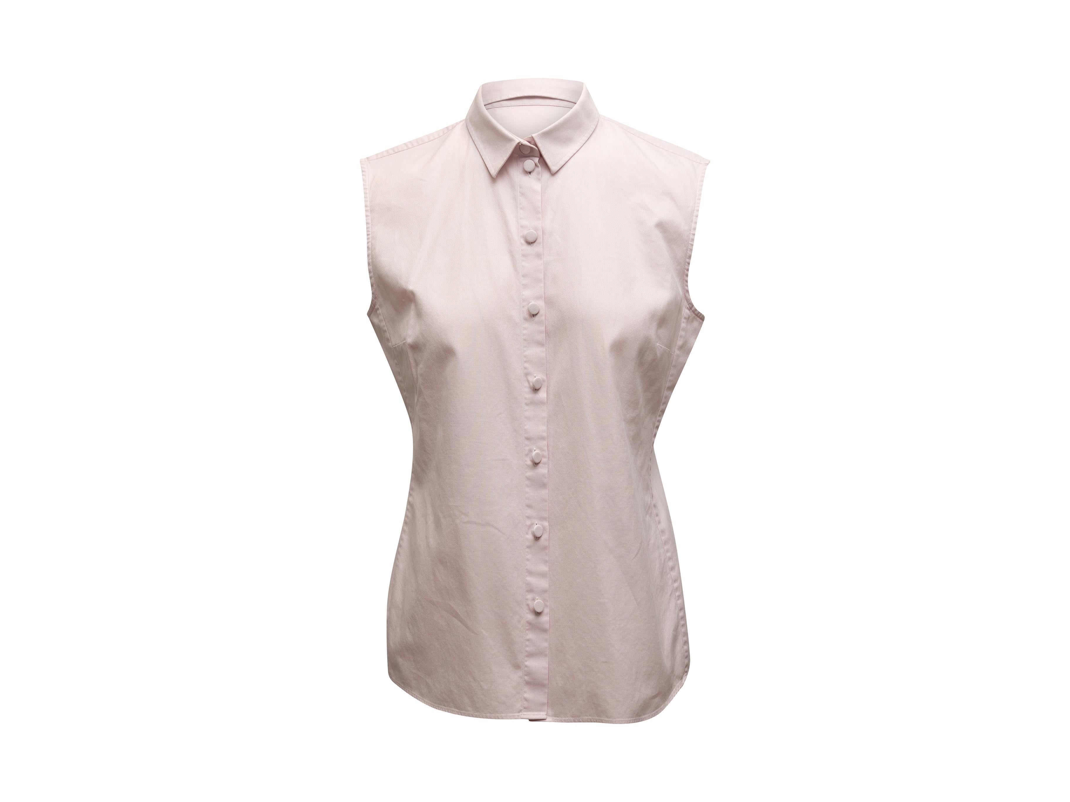 Product details: Light pink sleeveless button-up top by Christian Dior. Pointed collar. Button closures at center front. 35