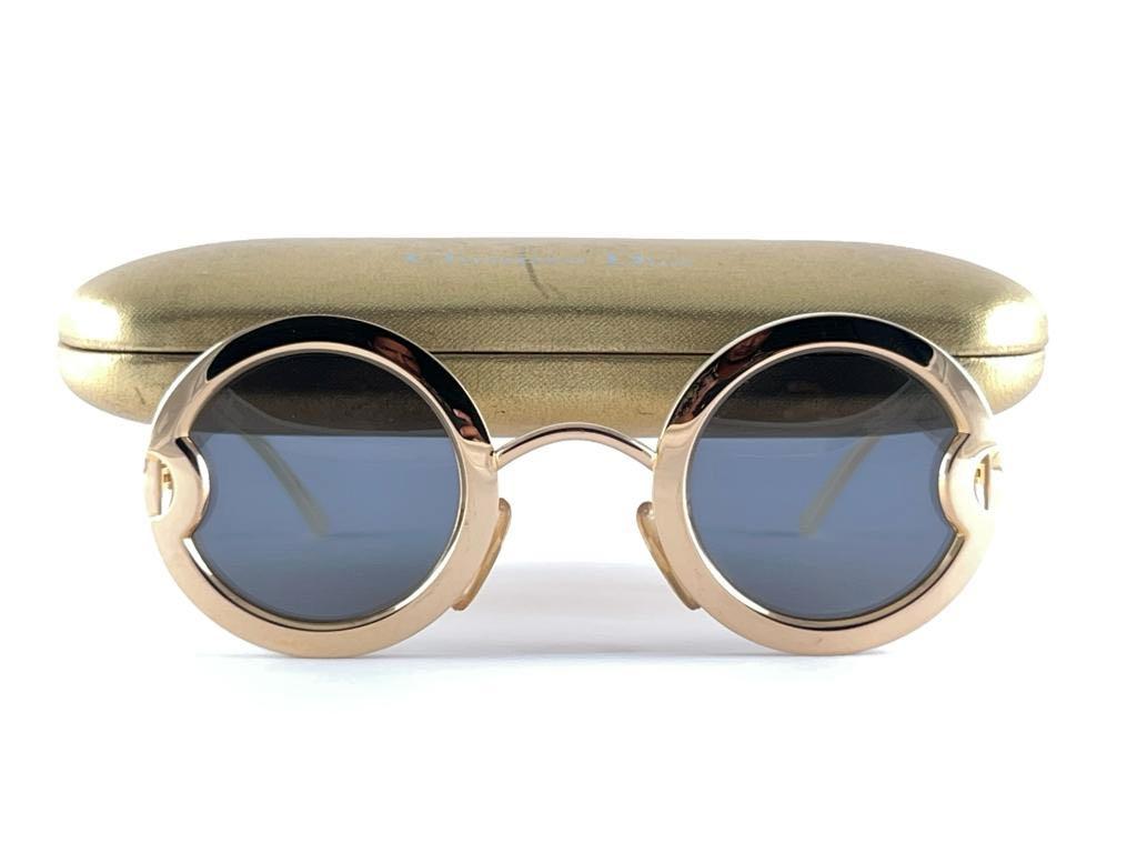Ultra rare pair of Christian Dior Sunglasses. Round Gold plated sunglasses backed by two mother of pearl acetate circles. CD written on the gold temples.

This is a rare piece. Limited edition, with serial number on the temple.

Please notice that