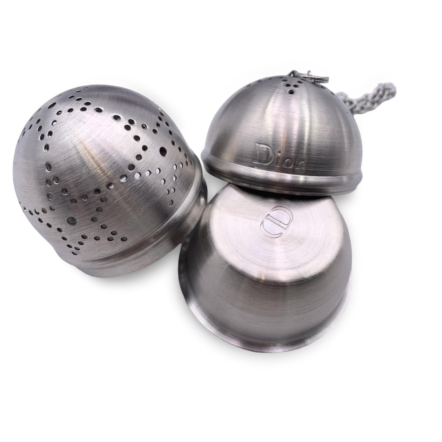 Beautiful set of 3 tea infusers by Christian Dior. The set consists of three silver metal tea infusers with plates. Each infuser nillustrates an iconic facet of the House of Dior style: Houndstooth, Cannage and Christian Dior's Lucky star. 'Dior'
