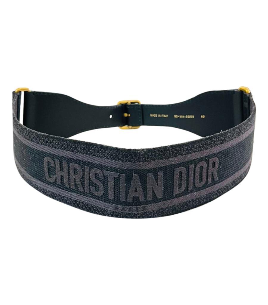 Christian Dior Logo Canvas & Leather Embroidered Belt

Black and grey canvas belt with signature branding to rear.

Detailed with black adjustable leather strap and aged gold buckle to the front.

Size – 80cm

Condition – Very
