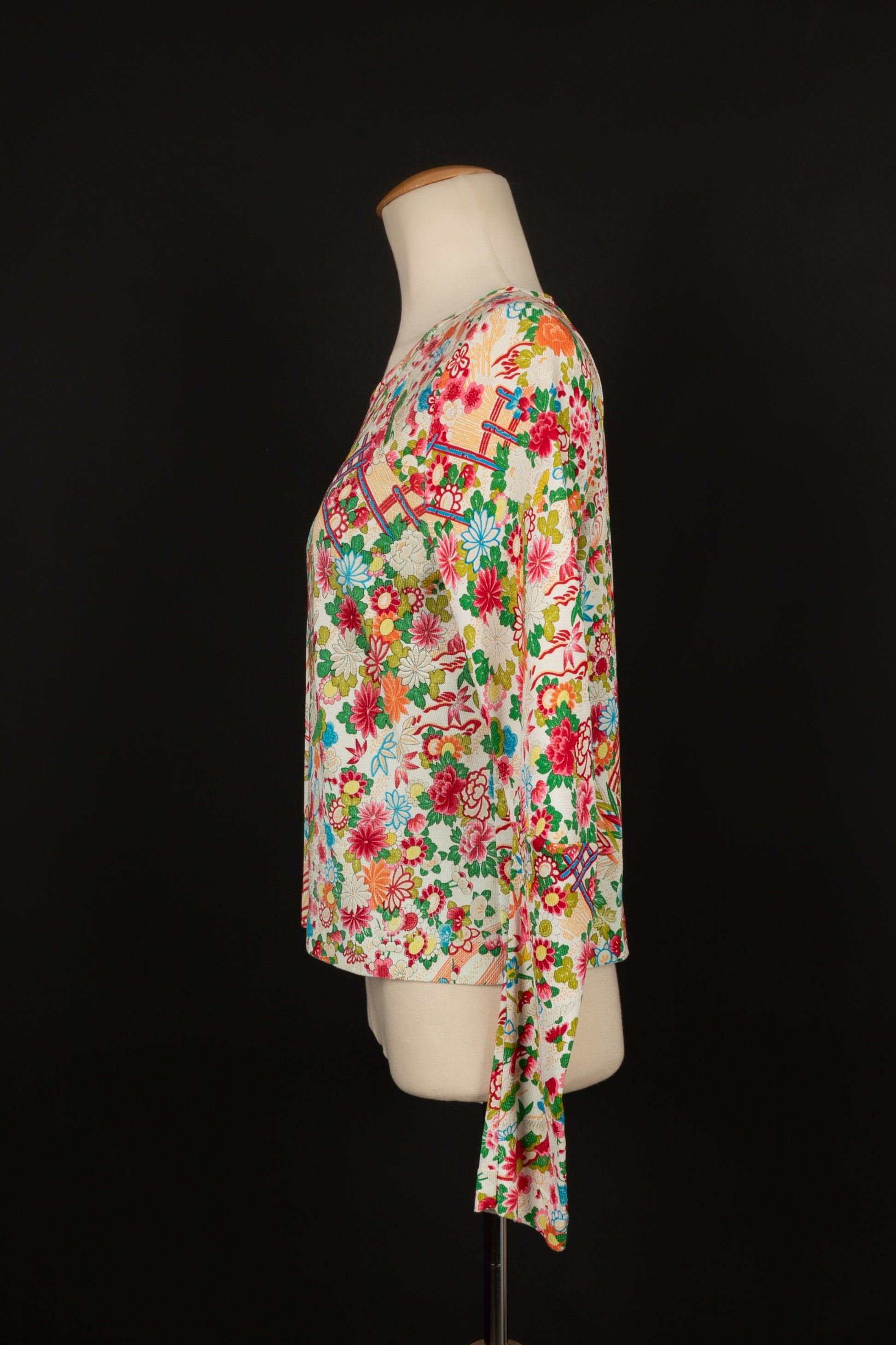 Dior- Long-sleeved top with multicolored flower patterns. No size indicated, it fits a 36FR.

Additional information:
Condition: Very good condition
Dimensions: Shoulder width: 36 cm - Chest: 48 cm - Sleeve length: 68 cm - Length: 53 cm
Seller