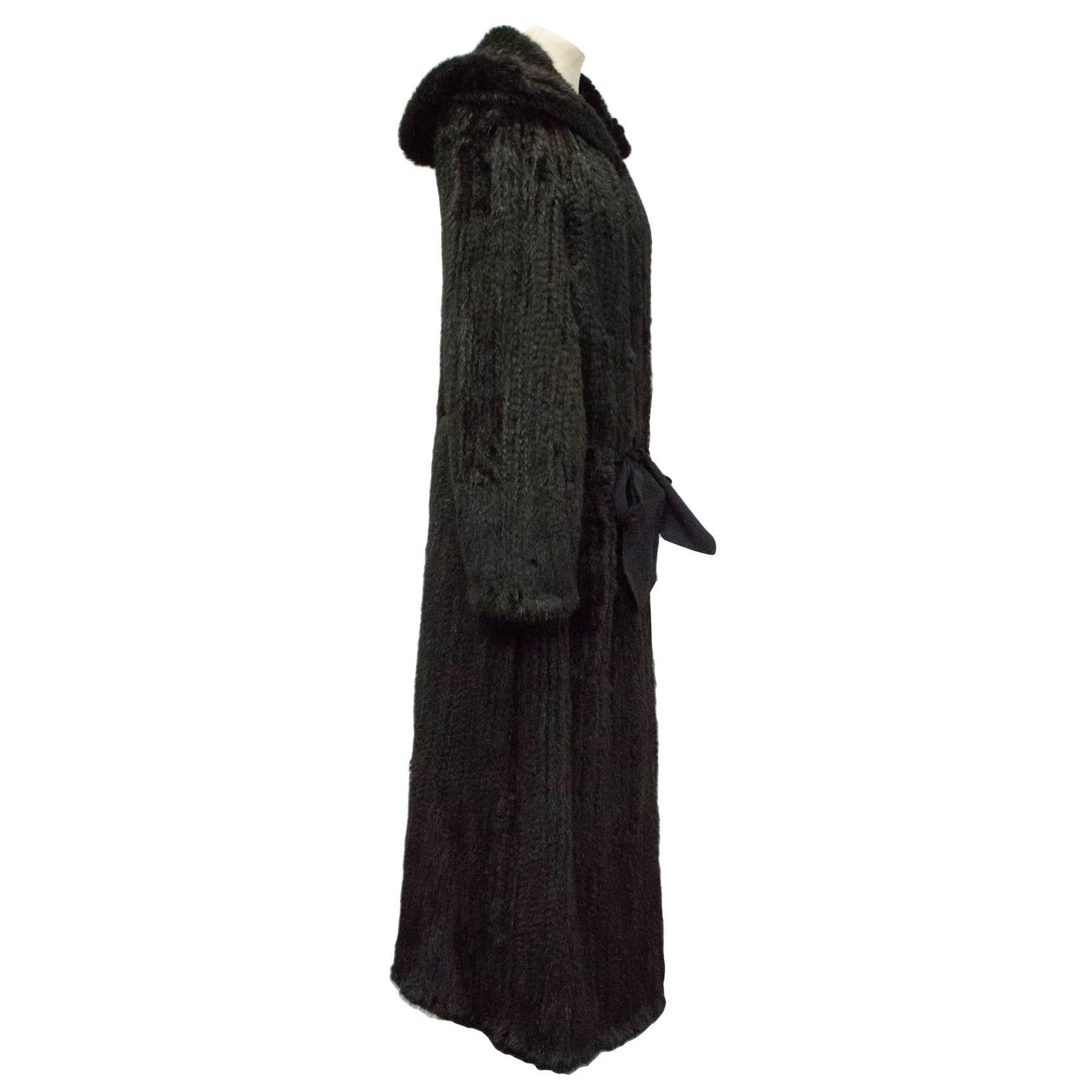 Christian Dior knitted mink fur coat with hood, in an elegant full-length gown-style with tie-up fastening and removable shoulder pads.

Lightweight, stunning and timeless piece.

Please note this item is missing a care label. 

Approx