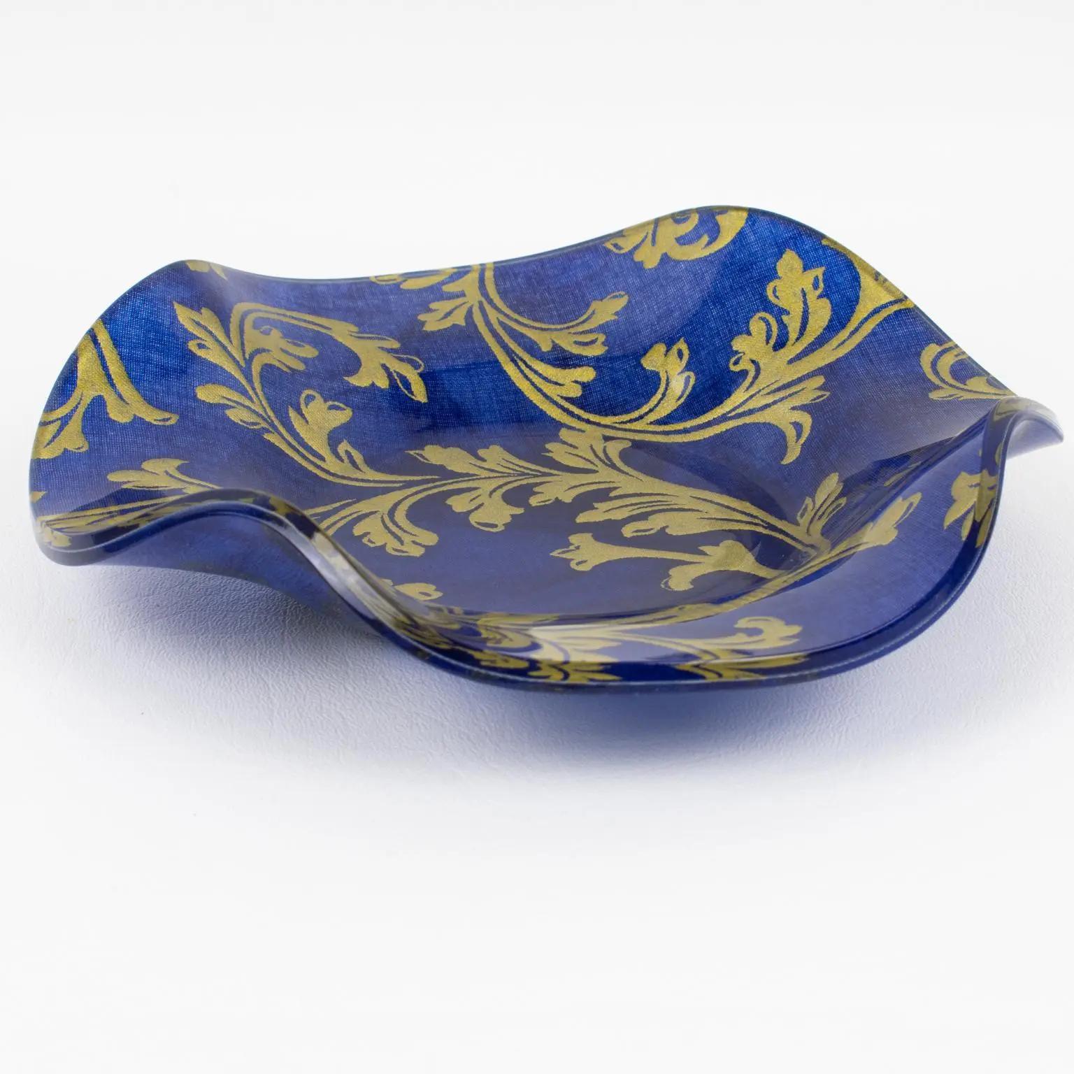 This is a romantic set of two decorative bowls, centerpieces, or catchalls designed for the Christian Dior Home Collection. Rounded scalloped shape in Lucite with authentic cobalt blue and gold Toile de Jouy embedded into the material. The Christian