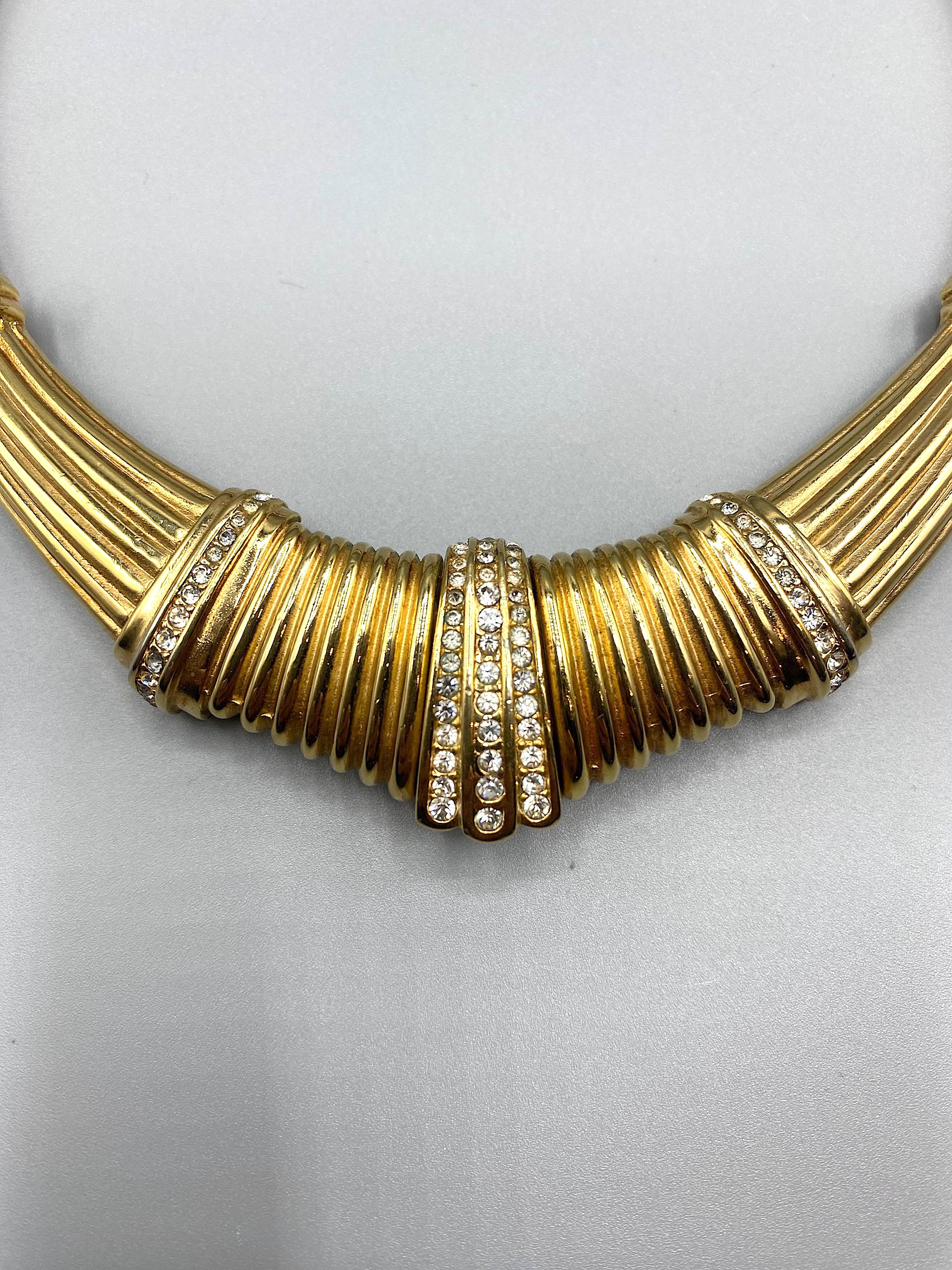 Magnificent Christian Dior  1980's Art Deco Style, Gold with rhinstone Omega necklace, with a rigid geometrical center.
Heavy gold plate.
The rigid gold center with rhinstones measures 5