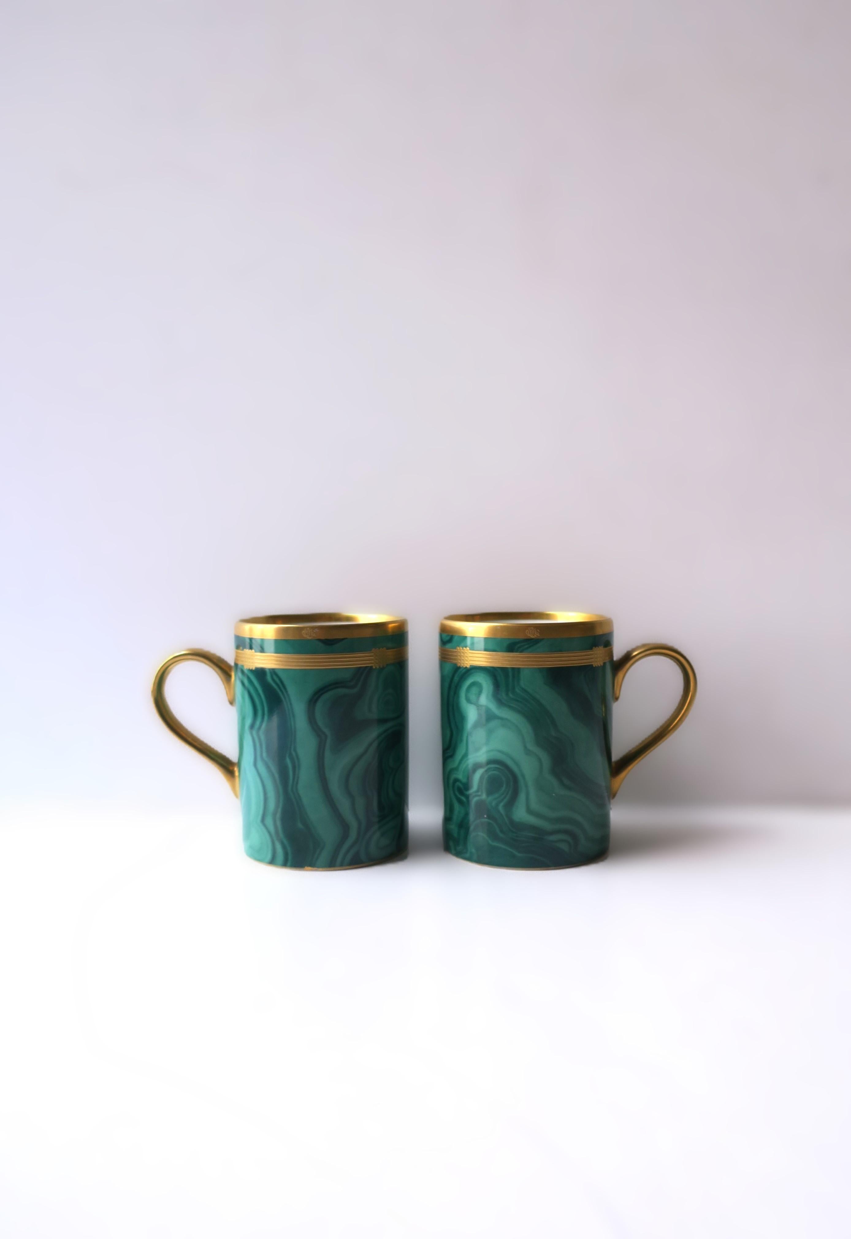 A beautiful and rare pair/set of two (2) 'Guadron' malachite green and gold porcelain cups from French luxury Maison, Christian Dior, circa late-20th century. A great set of cups for coffee, tea, hot coco, etc. Raised markers' mark 'CD' on edge and