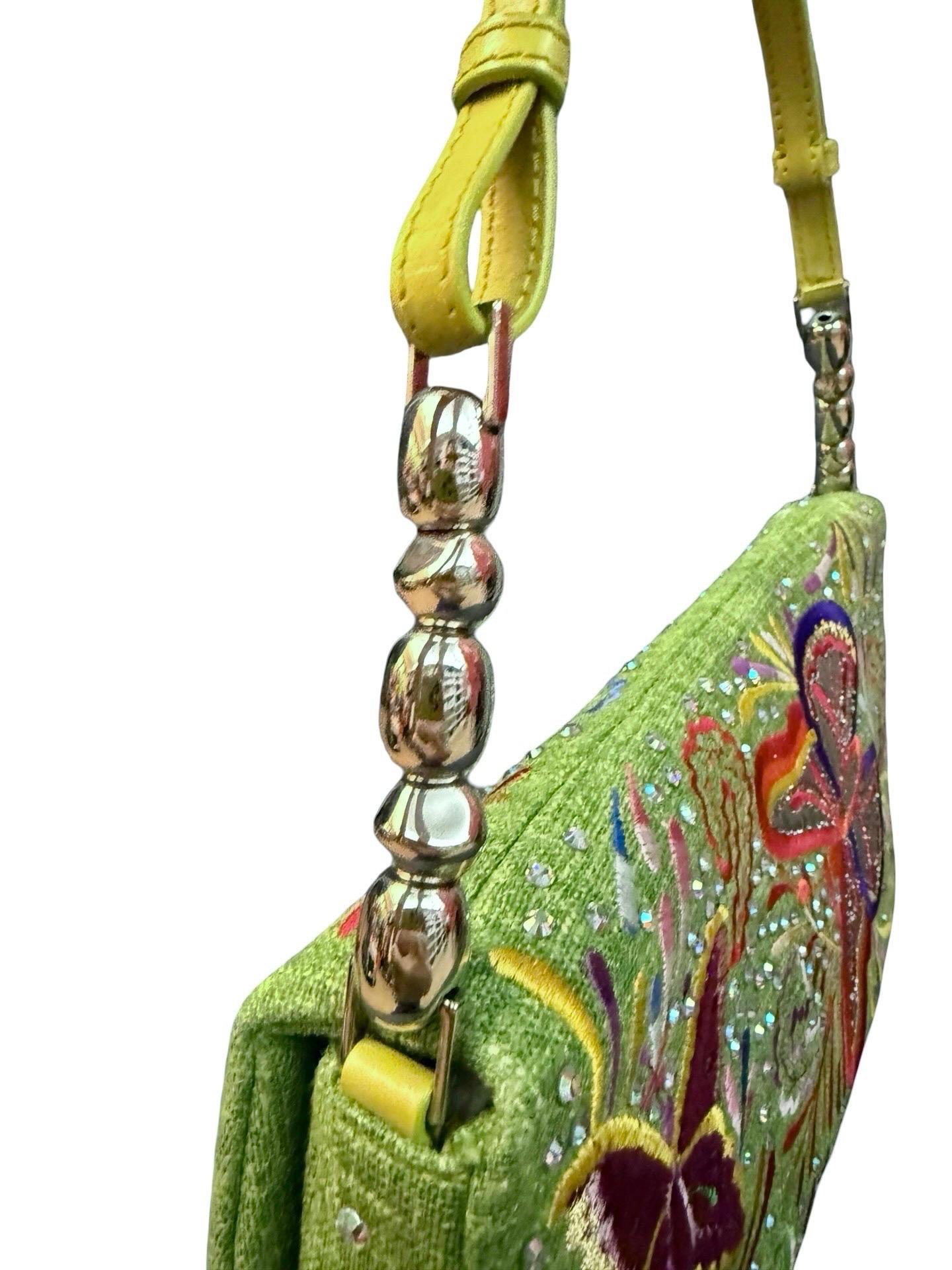 - Christian Dior green canvas and leather shoulder bag with multi color floral and butterfly embroidery and rhinestones accents, circa 2001 edition. 

- Floral and butterfly design. 

- Flap magnetic closure. 

- Green satin lining. 

- Interior zip
