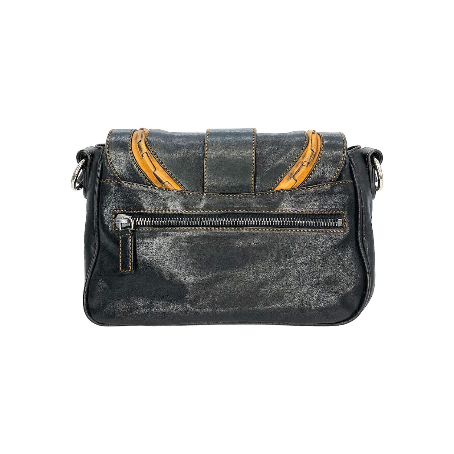 This Christian Dior Medium Gaucho Crossbody Saddle Bag was made in Italy and it is finely crafted of a calfskin leather exterior with silver-tone hardware features. It has an adjustable flat leather shoulder strap. It has a zipper pocket on the