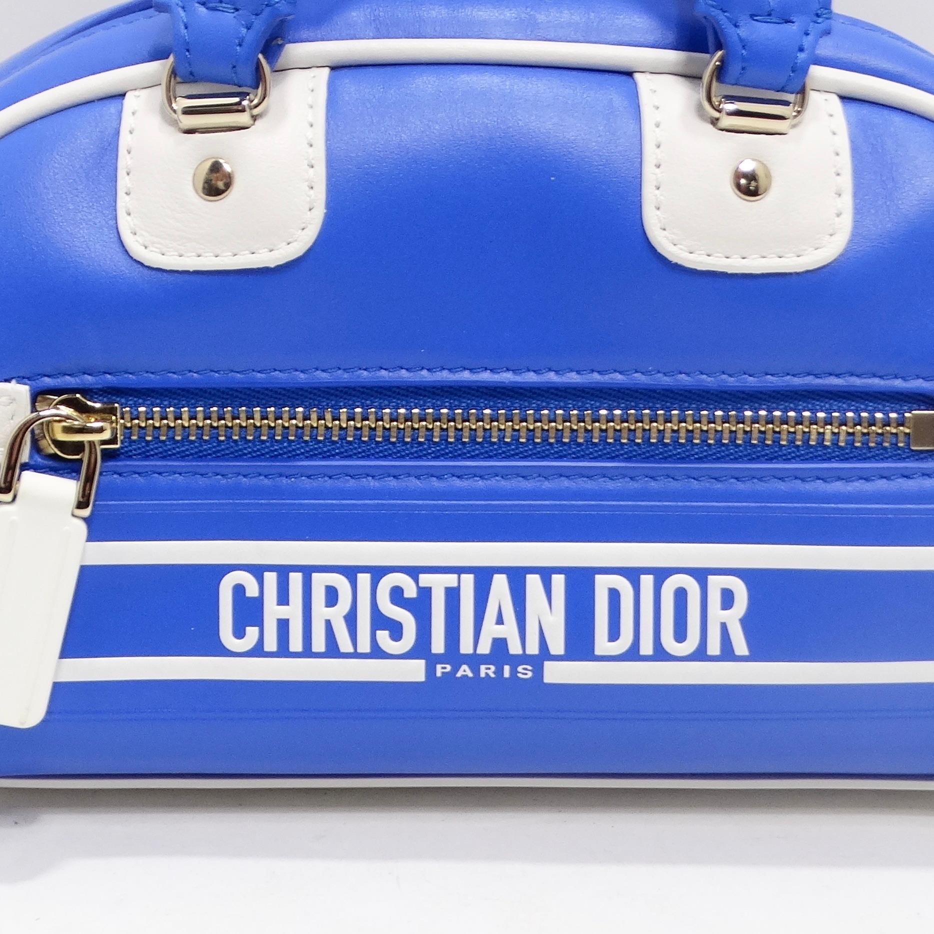 Introducing the Christian Dior Micro Vibe Zip Bowling Bag in Electric Blue Leather – a true embodiment of luxury and sportswear chic from the Summer 2022 fashion show. This micro-sized masterpiece showcases Maria Grazia Chiuri's couture spirit,