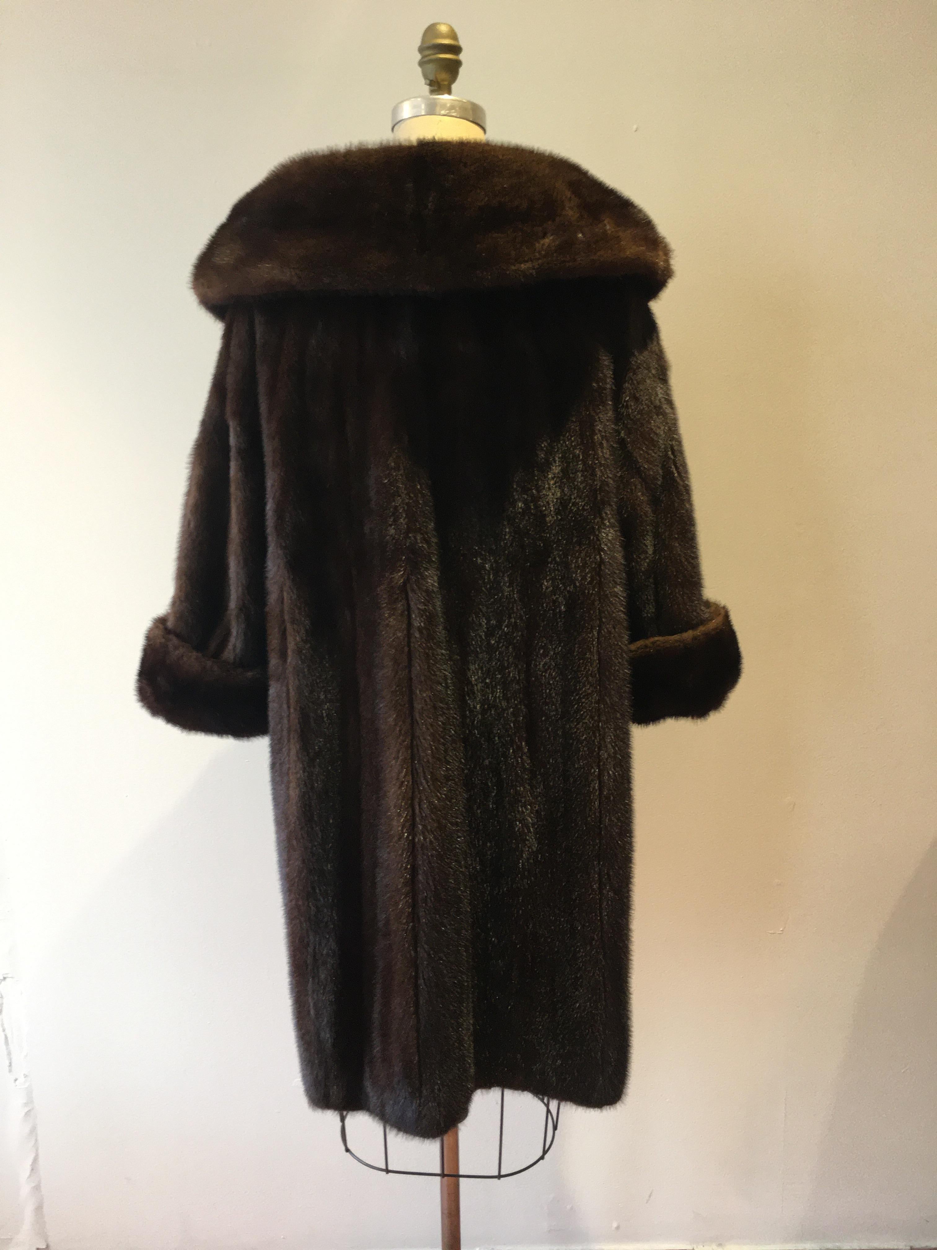 This gorgeous mink coat was designed by Christian Dior for Holt Renfrew. It is in great vintage condition, nice and glossy and still in style. It has a lovely shawl collar; turned up cuffs and pockets, as well as lining silk ties at the waist.