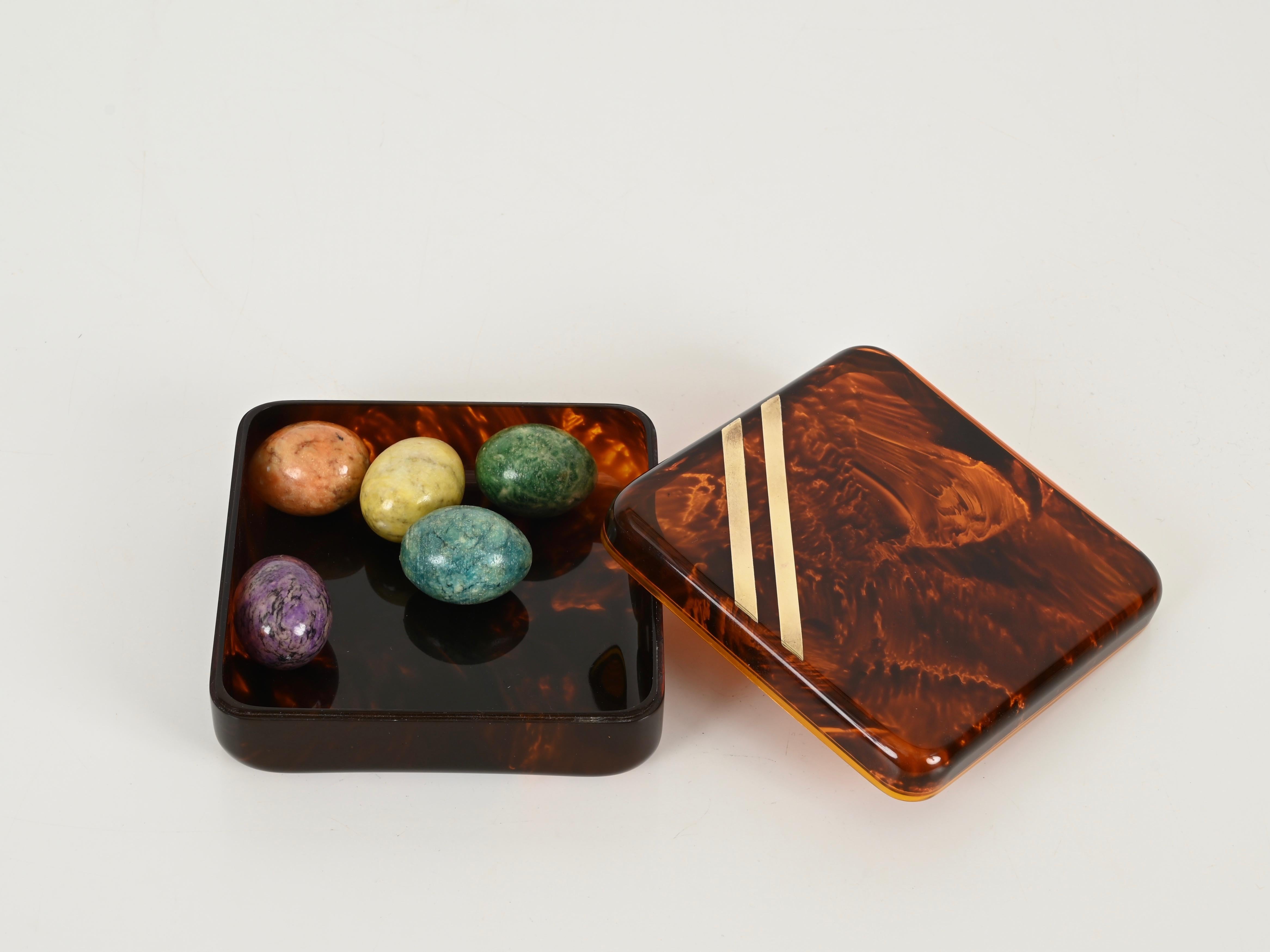 Gorgeous mid-century square shaped decorative jewelry box in an elegant tortoiseshell effect lucite and brass. This fantastic piece was designed in France during the 1970s for Christian Dior Home production.

This piece, is in its unique elegance,