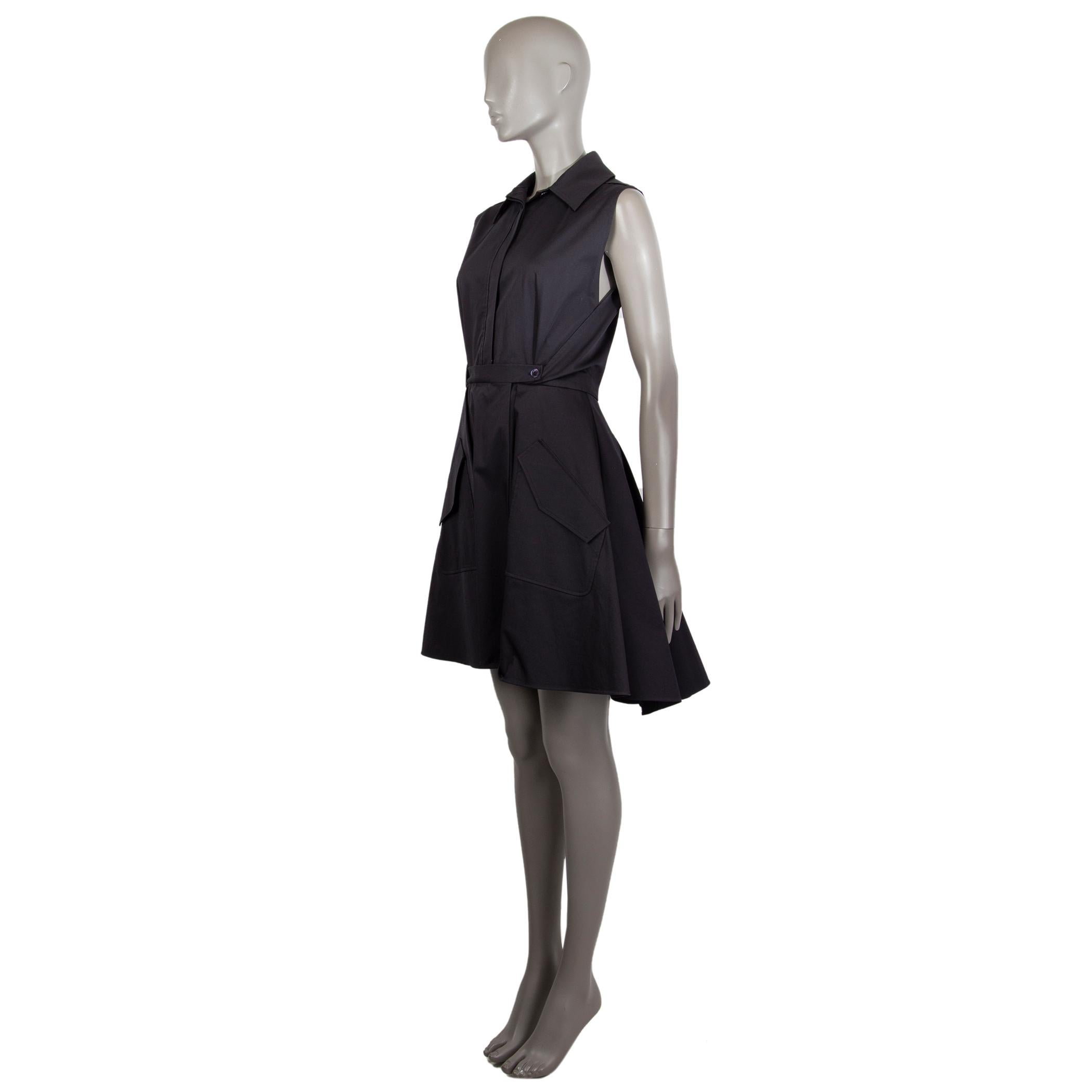 Christian Dior sleeveless draped shirt dress in midnight blue cotton blend (assumed as tag is missing) with a flat collar. Has two deep asymmetrical pockets on the front. Its built-in skirt buttons around the inside. Closes fully on the front with