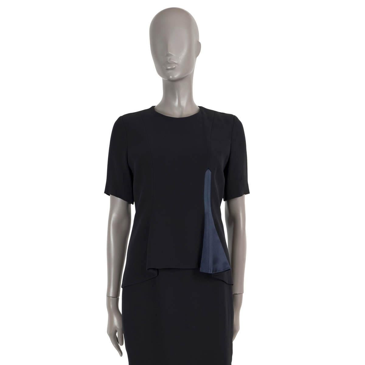 100% authentic Christian Dior short sleeve dress in Midnight Blue silk (100%). Features a round neck and peplum layer on the front with ink blue asymmetric detail. Opens with a concealed zipper in the back and is lined in silk (100%). Has been worn