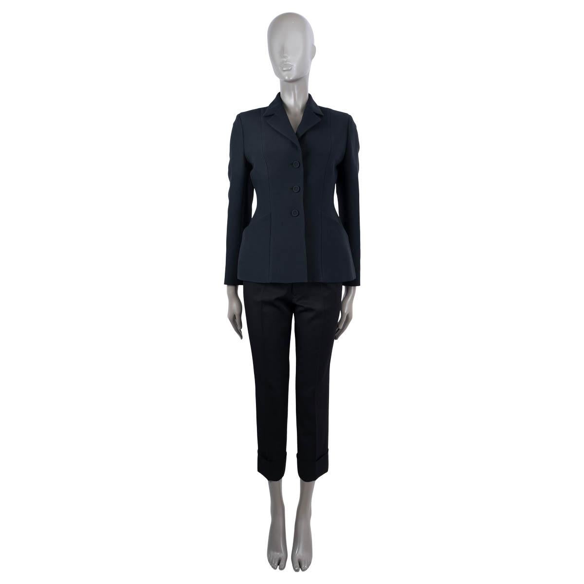 100% authentic Christian Dior 30 Montaigne Bar jacket in midnight blue wool (77%) and silk (23%). Features a tailored, yet supple silhouette with delicately highlight waist, notch lapels and welt pockets. Closes with fabric covered buttons on the