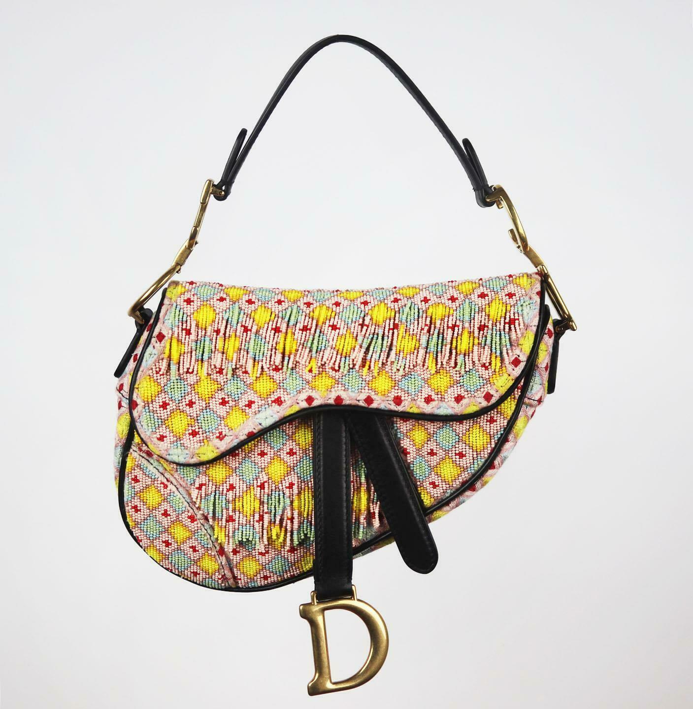 Made in Italy, this beautiful Christian Dior 'Saddle' handbag has been made from multicoloured fringed beaded embellishment and black calfskin exterior with matching black suede interior, this piece is decorated with Dior's gold finish hardware on