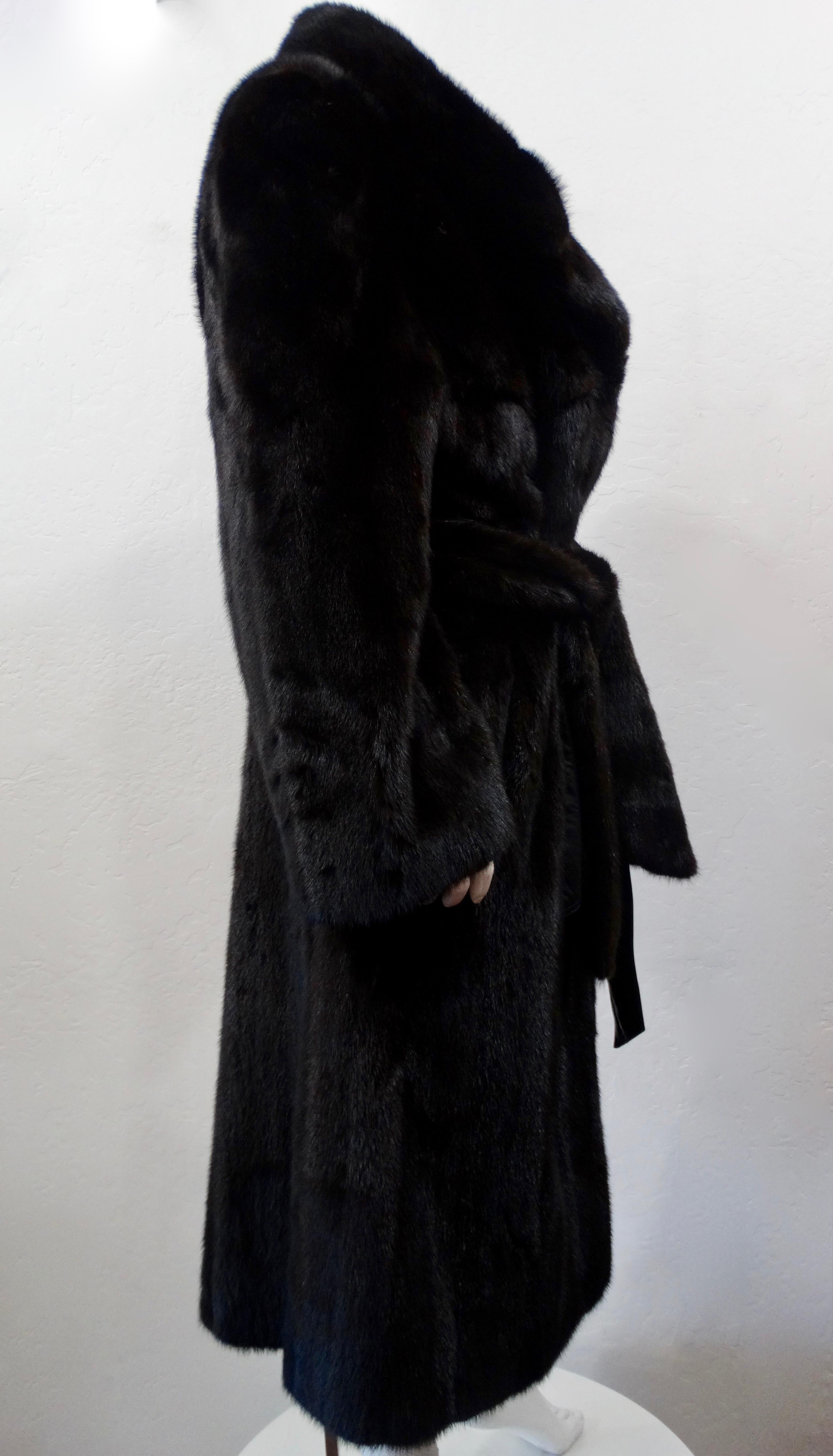 Stay cozy and stylish all winter long with this amazing Christian Dior coat!Custom made in 1978 this long fur coat is made of soft dark brown mink fur and features a shawl collar and dual front buttons. Includes a tie leather belt and a tonal mink