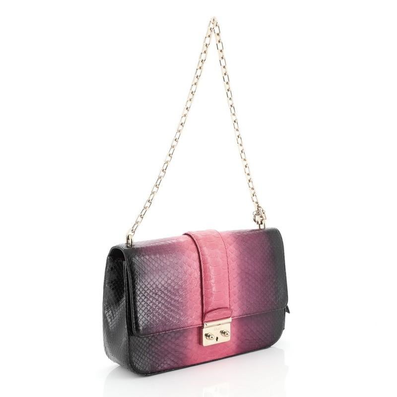 This Christian Dior Miss Dior Flap Bag Ombre Python Medium, crafted from genuine pink and purple ombre python skin, features a chain link strap, frontal flap and gold-tone hardware. Its push-lock closure opens to a pink leather interior with slip