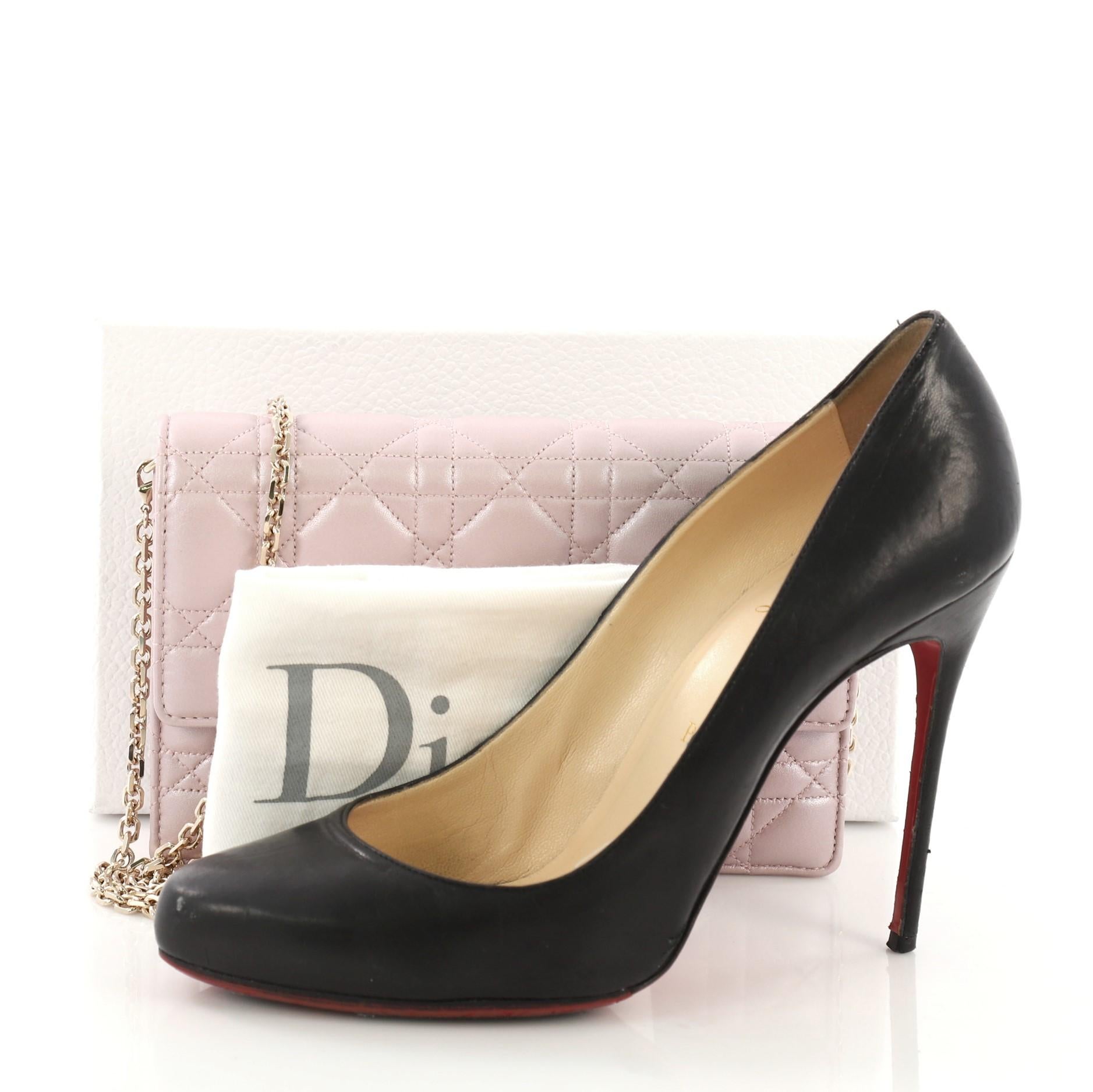 This Christian Dior Miss Dior Promenade Wallet on Chain Cannage Quilt Iridescent Leather Large, crafted from pink quilted iridescent leather, features chain-link shoulder strap and gold-tone hardware. Its flap with push-lock closure opens to a pink
