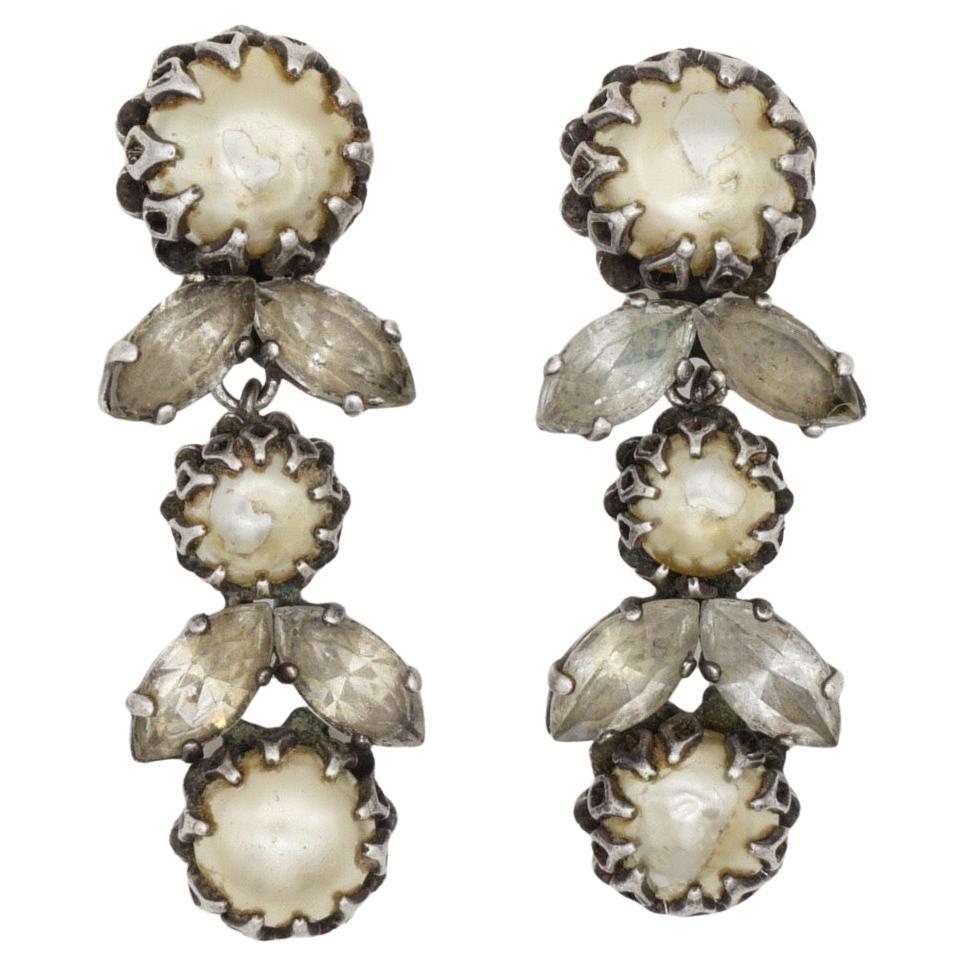 Christian Dior by Mitchel Maer 1950s White Pearls Crystals Flower Leaf Long Drop Dangle Clip Earrings, Silver Tone

Mitchel Maer was a prominent American designer who lived in England during the 1950s. During this time, he created jewellery under