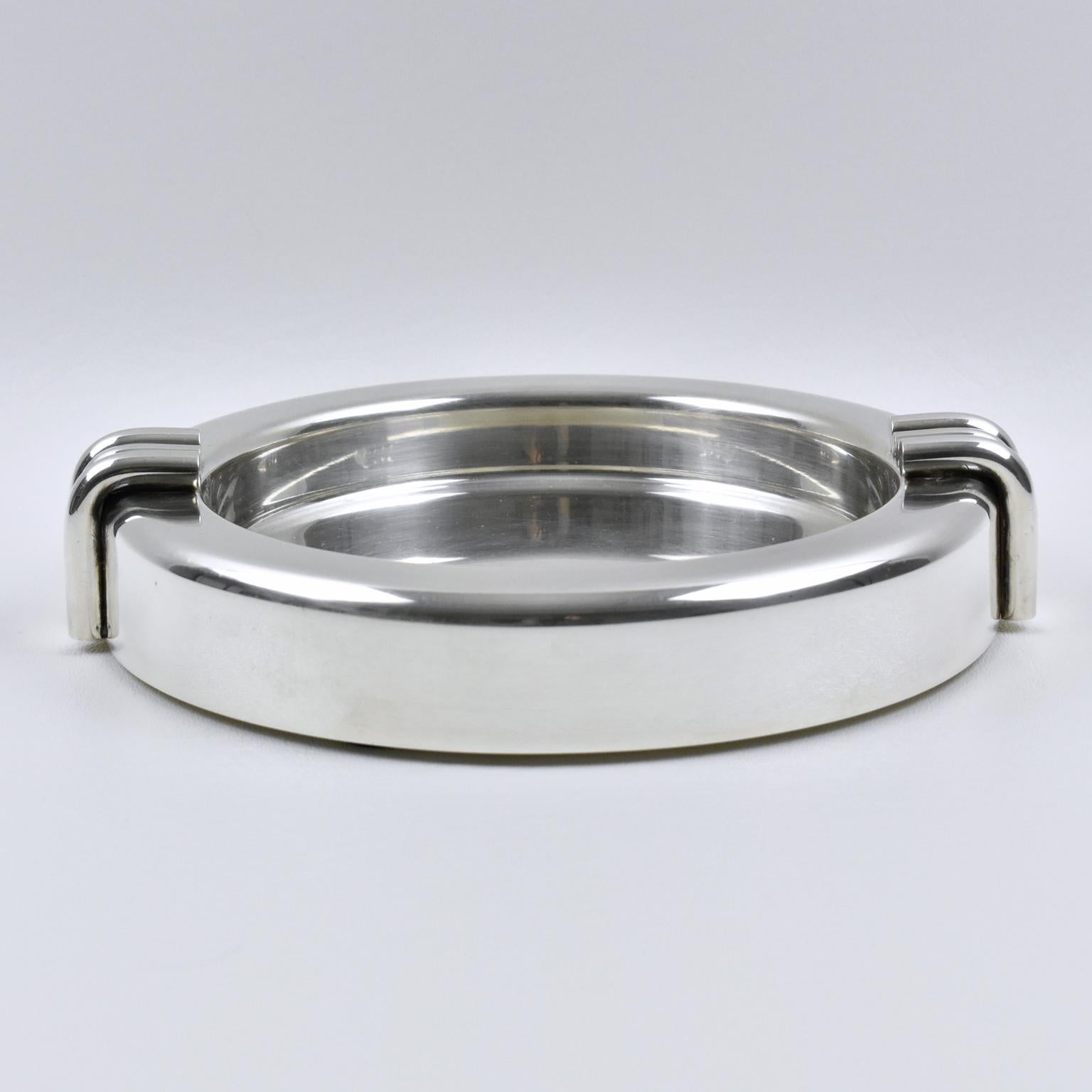 Elegant Christian Dior, Paris modernist large cigar ashtray or desk accessory. This silver plate sophisticated catchall features iconic streamline design with clean lines. Marked underside: Christian Dior.
Measurements: 7.88 in. diameter (20 cm) x