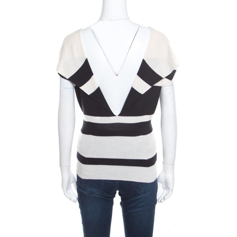 Creations from Dior are absolutely worth buying since it knows how to flatter women well! This monochrome sweater top is made of a cashmere and silk blend and features a striped design. It flaunts a slightly boat neckline, short sleeves, and a