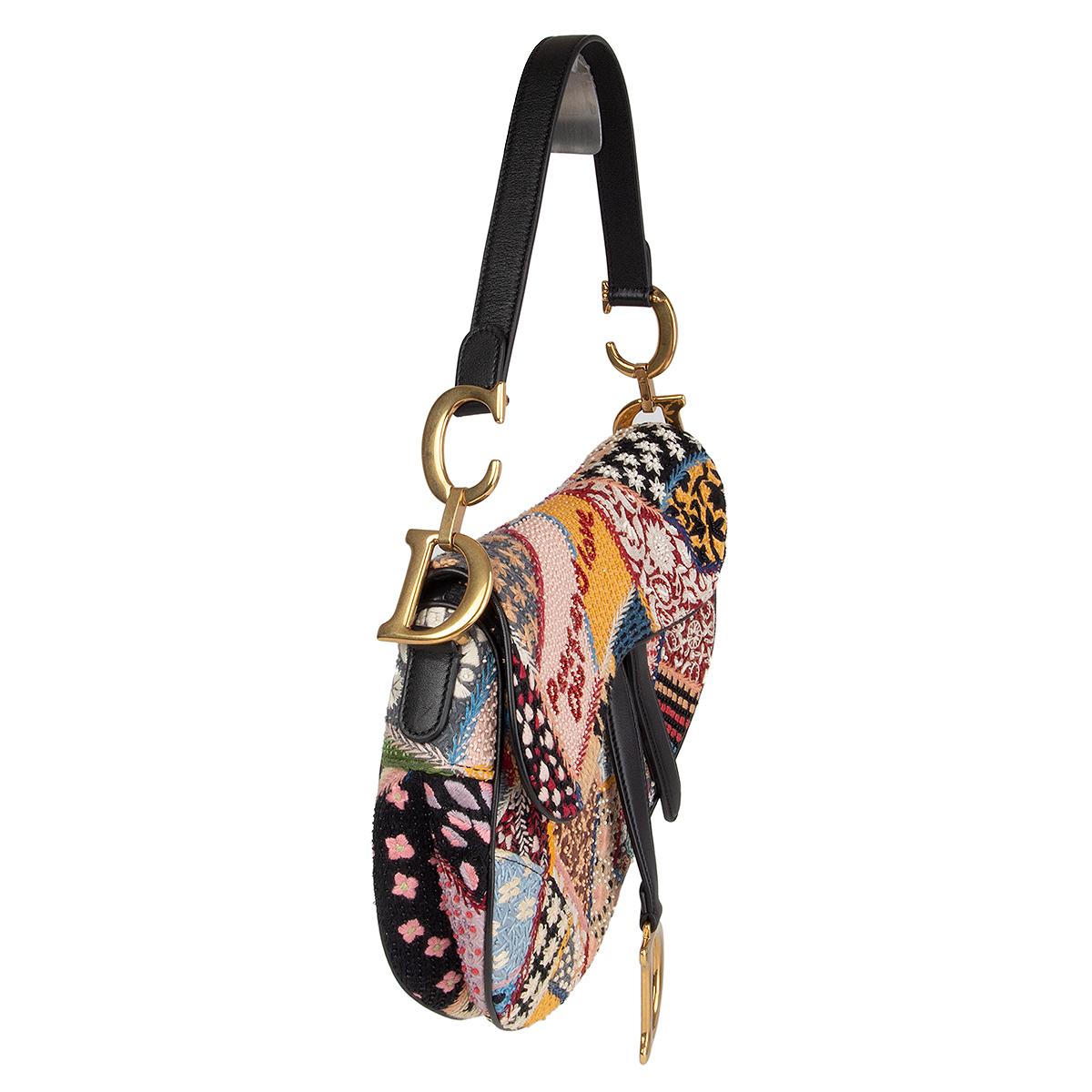 100% authentic Christian Dior 'Peace And Love Saddle' medium bag in multicolor fabric embellished with beads and embroidery featuring slip pocket on the back. Black calfskin shoulder strap front straps and piping. Lined in black suede with one