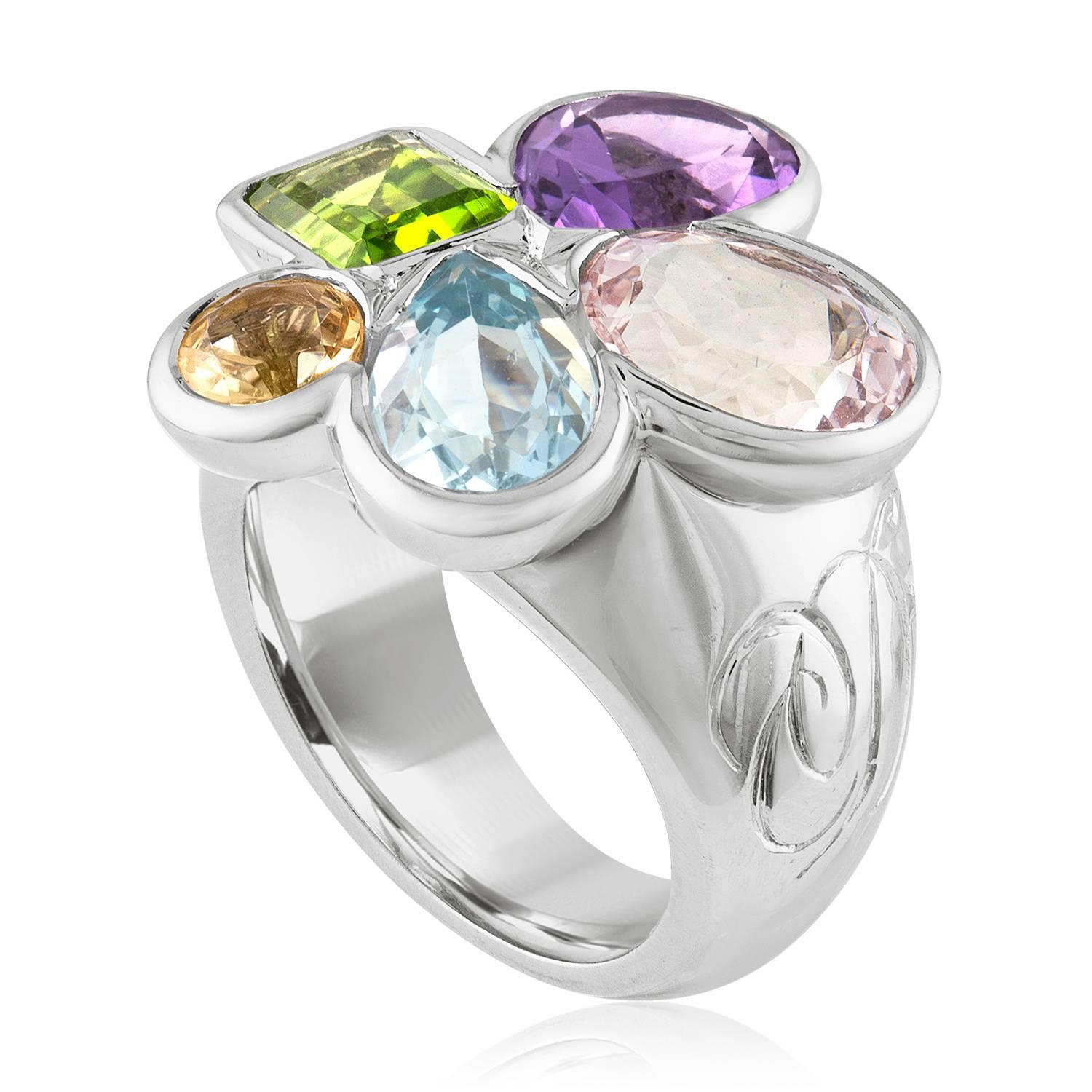 Stunning Large Cocktail Ring
The ring is 18K White Gold
The ring is by Christian Dior
There are 5 gem stones.
There is Amethyst, Peridot, Topaz, Citrine, and Kunzite
French hall marks on the outside of the band and serial number inside.
The ring is