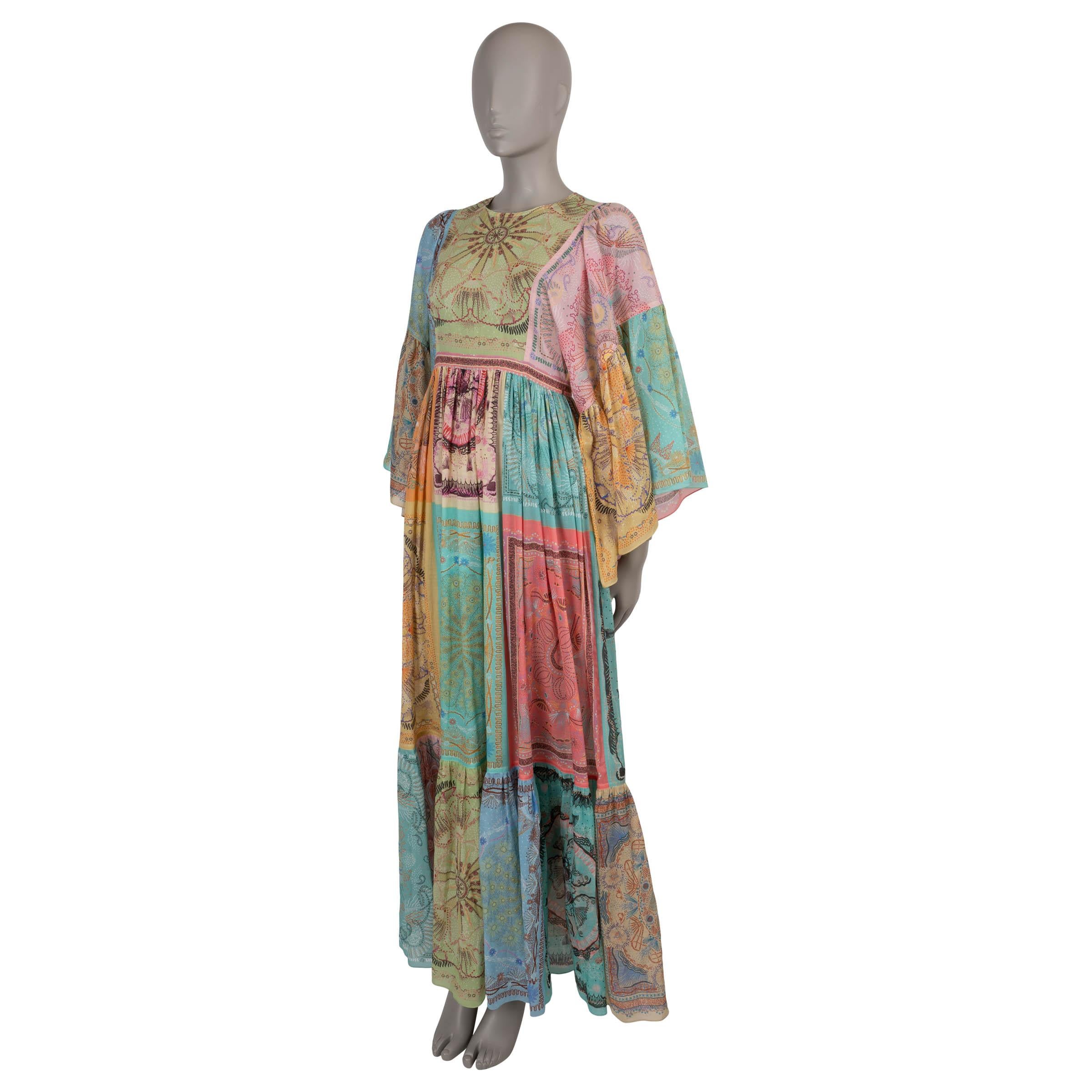 This 100% authentic Christian Dior prairie dress in multicolored voile cotton showcases a stunning patchwork of paisley-inspired prints, creating a beautifully bohemian aesthetic. Designed with a relaxed silhouette, it features a maxi length and an