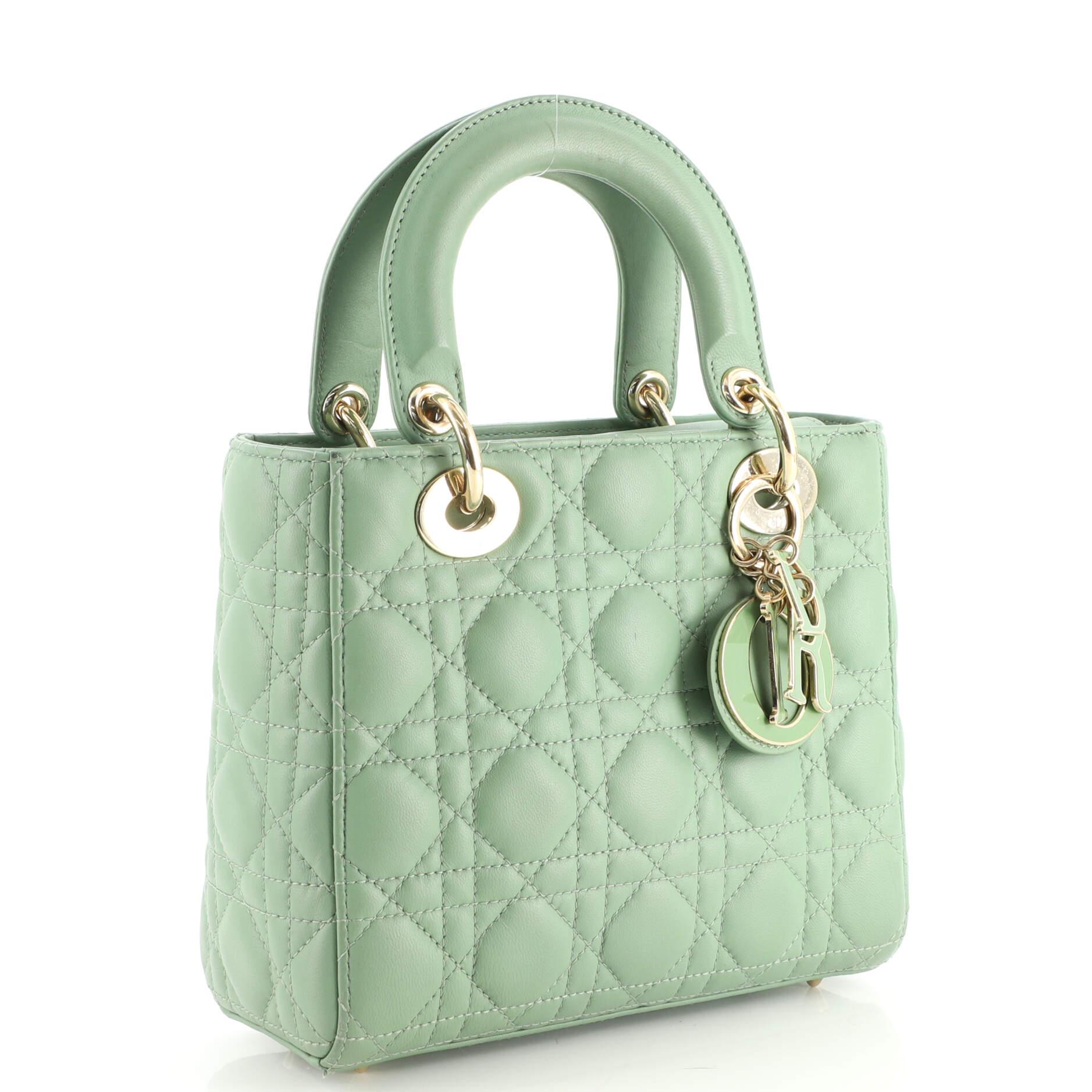 Condition: Fair. Creasing, wear, scuffs and small stains on exterior, handles and strap, moderate wear and darkening on base and opening corners, small indentations on base and strap. Heavy wear, discoloration and stains in interior, scratches on