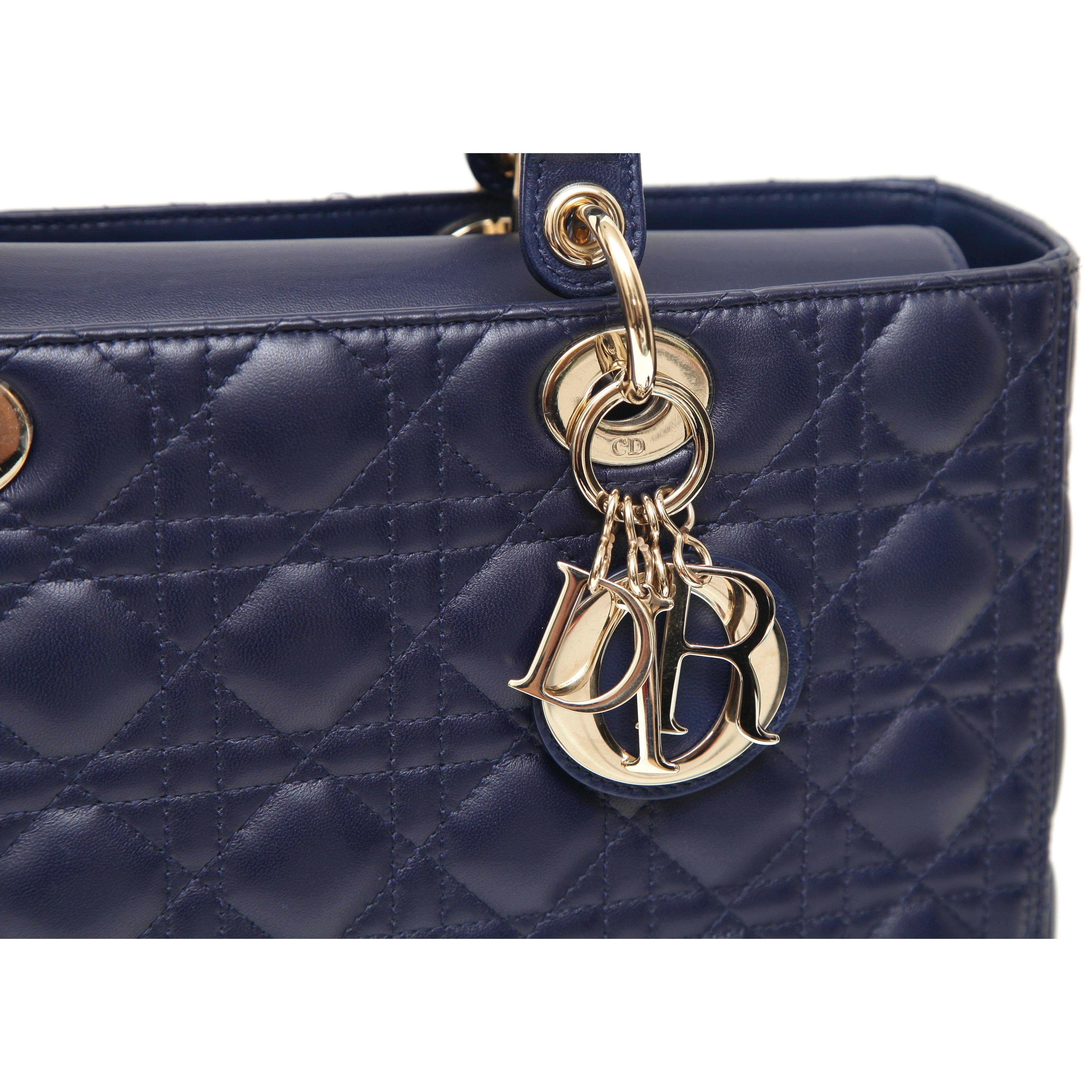 GUARANTEED AUTHENTIC CHRISTIAN DIOR LARGE NAVY BLUE LADY DIOR BAG

Retail excluding sales taxes $6,500

Design: 
- Navy blue lambskin leather Cannage Large Lady Dior Bag.
- Two top handles.
- Shiny gold-tone metal hardware.
- Top flap.
- Interior