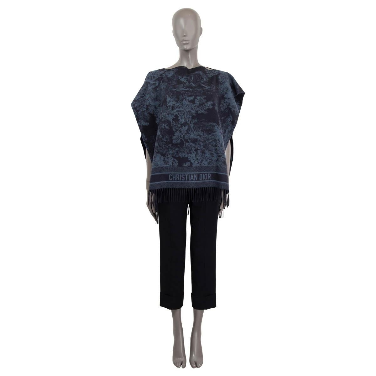 100% authentic Christian Dior 2020 fringed Toile de Jouy poncho in navy and blue cashmere (100%). Features fringes at the bottom and a boat neck. Has the Christian Dior font printed on the back. Has been worn and in excellent condition.