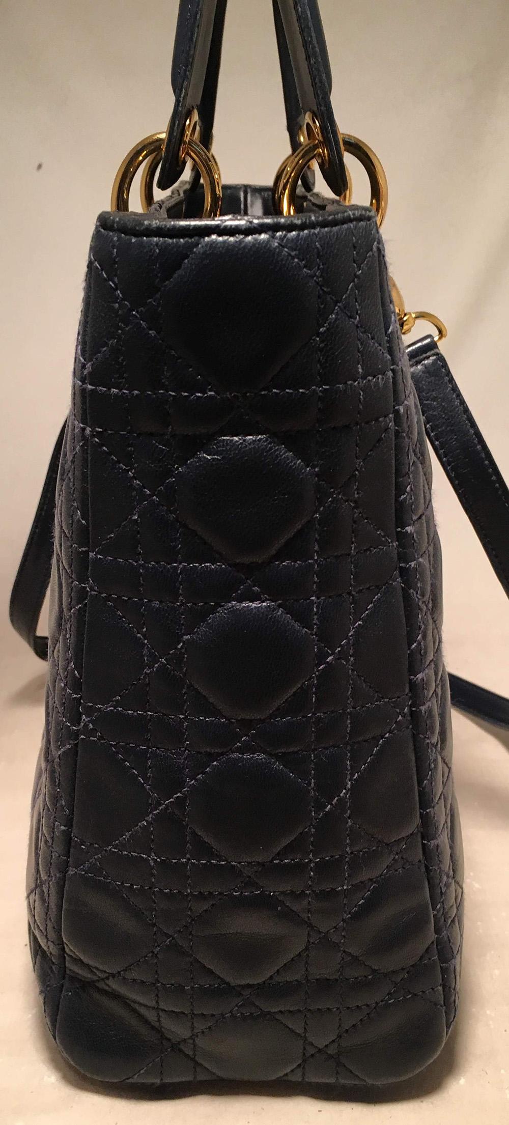 Christian Dior Navy Blue Leather Cannage Quilted Large Lady Dior Bag in excellent condition. Navy blue cannage quilted leather exterior trimmed with gold hardware and a removable matching leather shoulder strap. Top zipper closure opens to a red