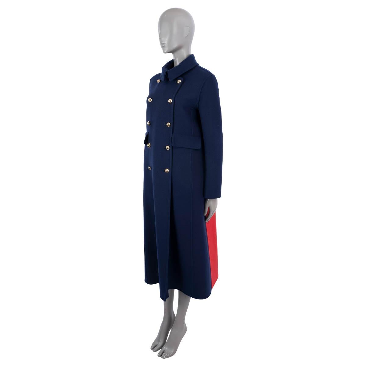 100% authentic Christian Dior double face long coat in navy blue, red and white cashmere (100%). The design features a double breasted front with light gold-tone CD embellished metal buttons, two front flap pockets and a box pleat on the back. Brand